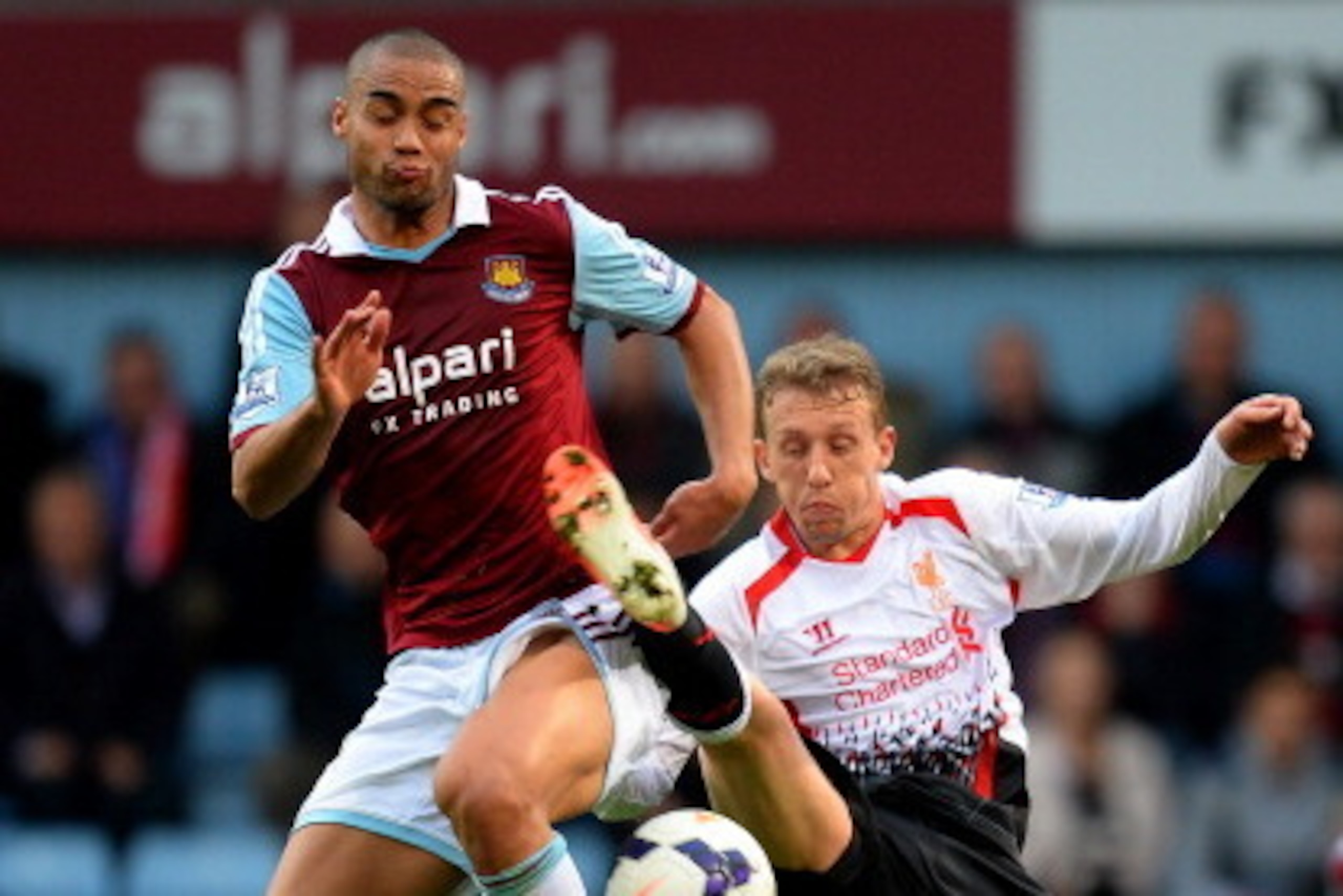 LONDON, ENGLAND - APRIL 06:  Winston Reid of West Ham and Lucas Leiva of Liverpool compete for the ball during the Barclays Premier League match between West Ham United and Liverpool at Boleyn Ground on April 6, 2014 in London, England.  (Photo by Mike He