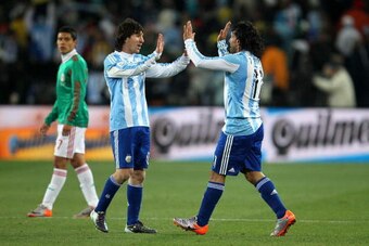 JOHANNESBURG, SOUTH AFRICA - JUNE 27:  Carlos Tevez of Argentina celebrates scoring his second goal and his side's third with team mate Lionel Messi during the 2010 FIFA World Cup South Africa Round of Sixteen match between Argentina and Mexico at Soccer 