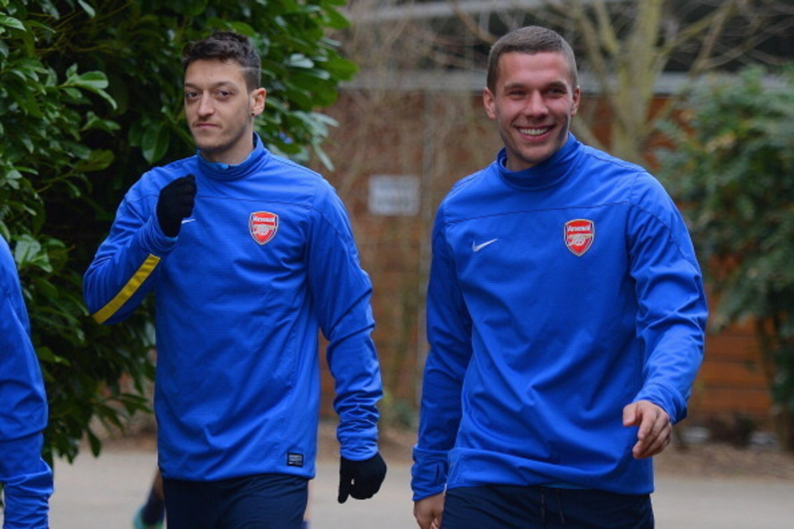 ST ALBANS, ENGLAND - MARCH 10:  Mesut Ozil and Lukas Podolski walk out during the Arsenal training session at London Colney on March 10, 2014 in St Albans, England.  (Photo by Michael Regan/Getty Images)