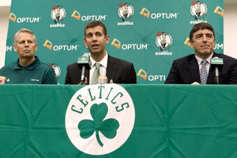 Jul 5, 2013; Waltham, MA, USA; Boston Celtics general manager Danny Ainge, left, and owner Wyc Grousbeck, right, listen as new Boston Celtics head coach Brad Stevens answers a question during a news conference announcing Stevens new position. Mandatory Cr