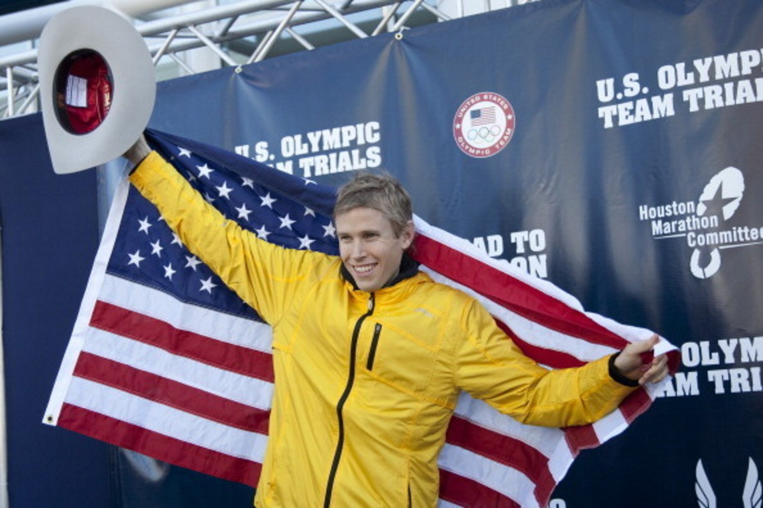 HOUSTON, TX - JANUARY 14:  Ryan Hall poses on the winners stage after qualifying at the U.S. Marathon Olympic Trials on January 14, 2012 in Houston, Texas.  (Photo by Bob Levey/Getty Images)