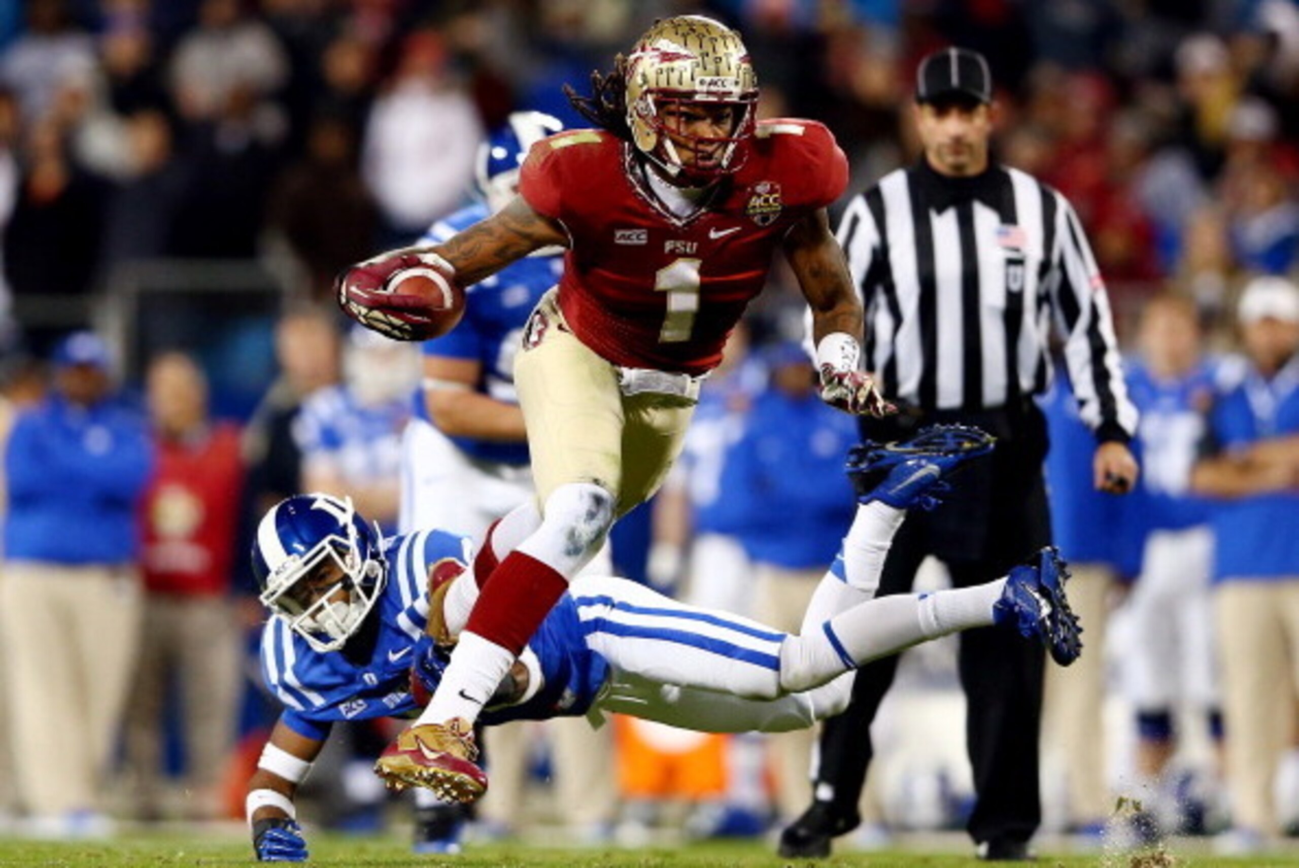 CHARLOTTE, NC - DECEMBER 07:  Wide receiver Kelvin Benjamin #1 of the Florida State Seminoles runs with the ball as cornerback Deondre Singleton #33 of the Duke Blue Devils defends during the ACC Championship game at Bank of America Stadium on December 7,