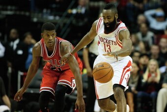HOUSTON, TX - DECEMBER 18:  James Harden #13 of the Houston Rockets drives with the ball against Jimmy Butler #21 of the Chicago Bulls during the game at Toyota Center on December 18, 2013 in Houston, Texas. NOTE TO USER: User expressly acknowledges and a