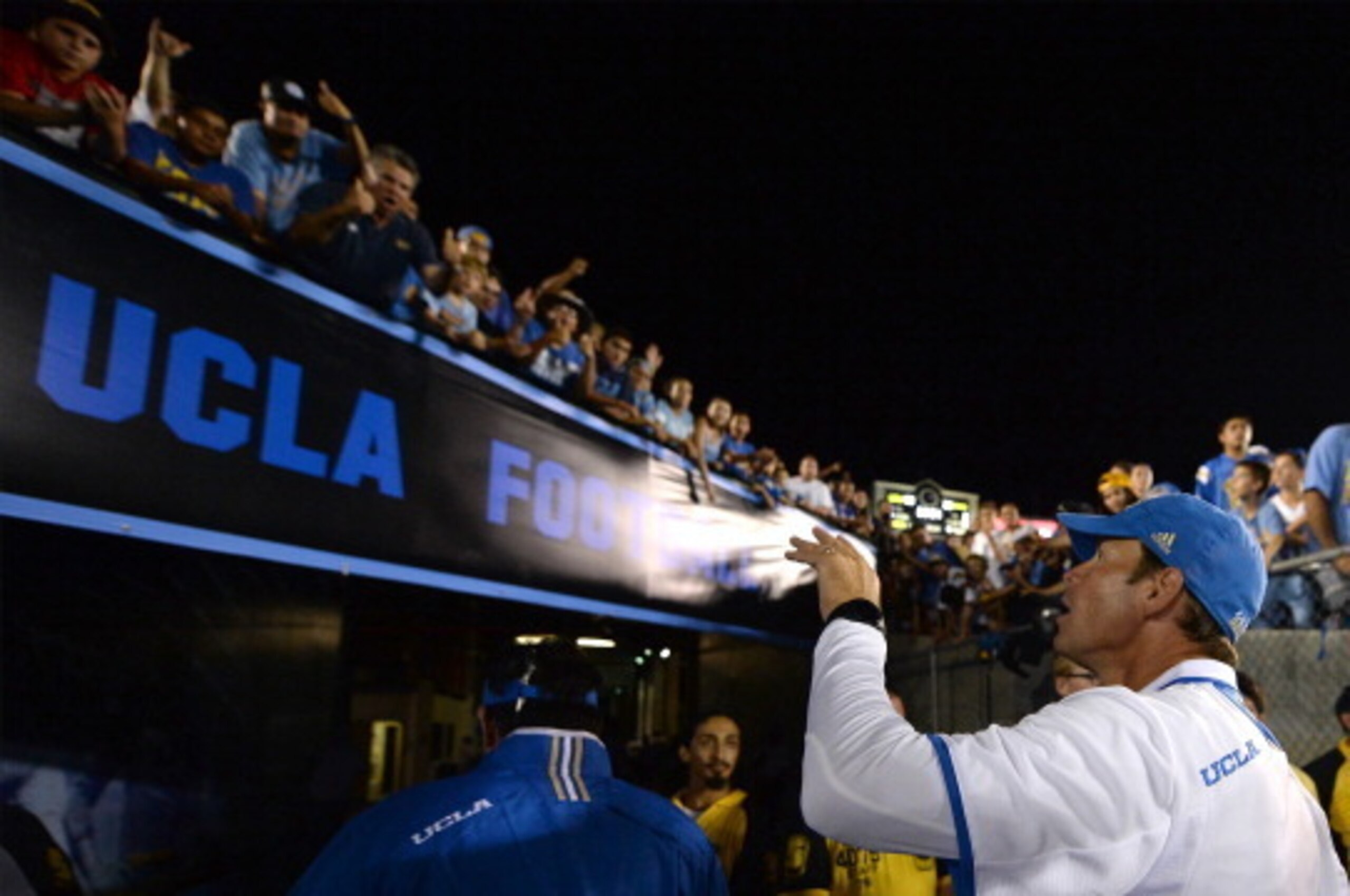 PASADENA, CA - AUGUST 31:  Head coach Jim Mora of the UCLA Bruins waves to fans as he exits the field after a 58-20 win over the Nevada Wolf Pack at Rose Bowl on August 31, 2013 in Pasadena, California.  (Photo by Harry How/Getty Images)