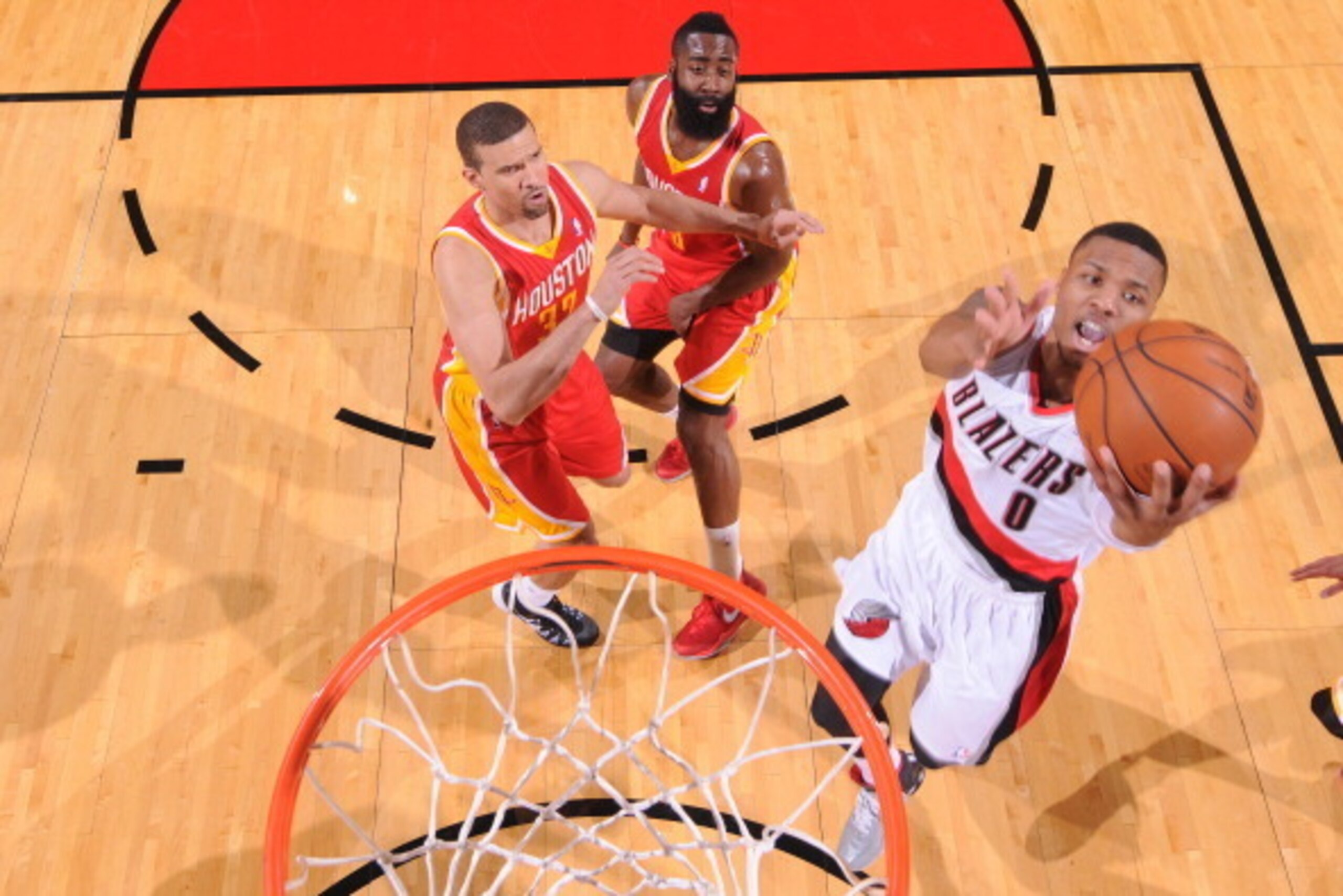 PORTLAND, OR - DECEMBER 12:  Damian Lillard #0 of the Portland Trail Blazers drives to the basket against the Houston Rockets on December 12, 2013 at the Moda Center Arena in Portland, Oregon. NOTE TO USER: User expressly acknowledges and agrees that, by 