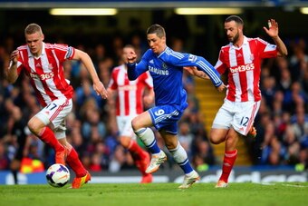 LONDON, ENGLAND - APRIL 05:  Fernando Torres of Chelsea is marshalled by Ryan Shawcross of Stoke City and Marc Wilson of Stoke City during the Barclays Premier League match between Chelsea and Stoke City at Stamford Bridge on April 5, 2014 in London, Engl