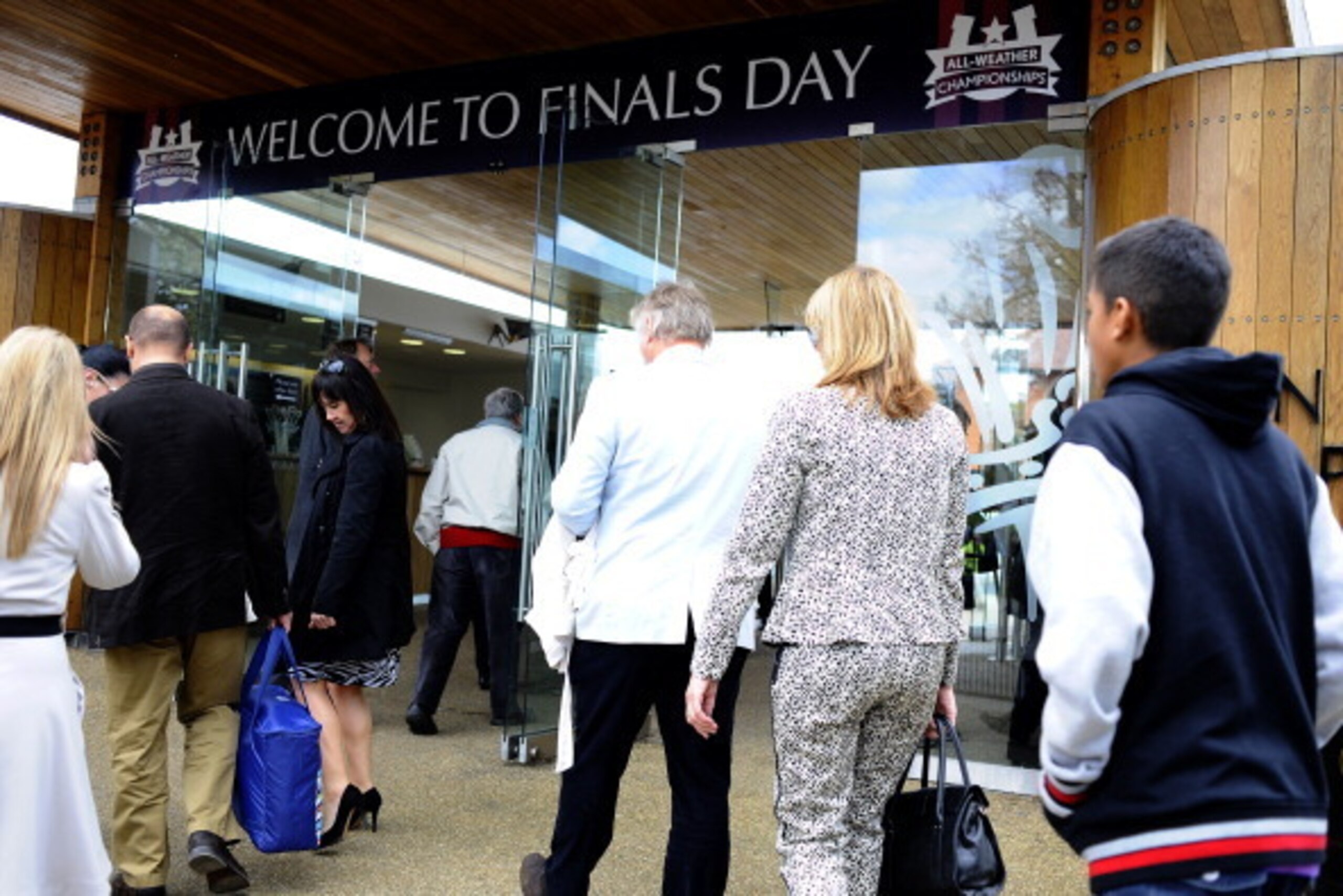LINGFIELD, ENGLAND - APRIL 18: Racegoers make their way through the entrance on the first ever horse racing fixture to be held on Good Friday at Lingfield racecourse on April 18, 2014 in Lingfield, England. (Photo by Alan Crowhurst/Getty Images)