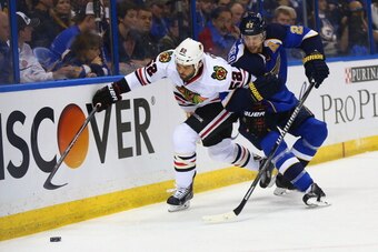 ST. LOUIS, MO - APRIL 17: Alex Pietrangelo #27 of the St. Louis Blues looks to keep Brandon Bollig #52 of the Chicago Blackhawks from getting to a loose puck in Game One of the First Round of the 2014 Stanley Cup Playoffs at the Scottrade Center on April 