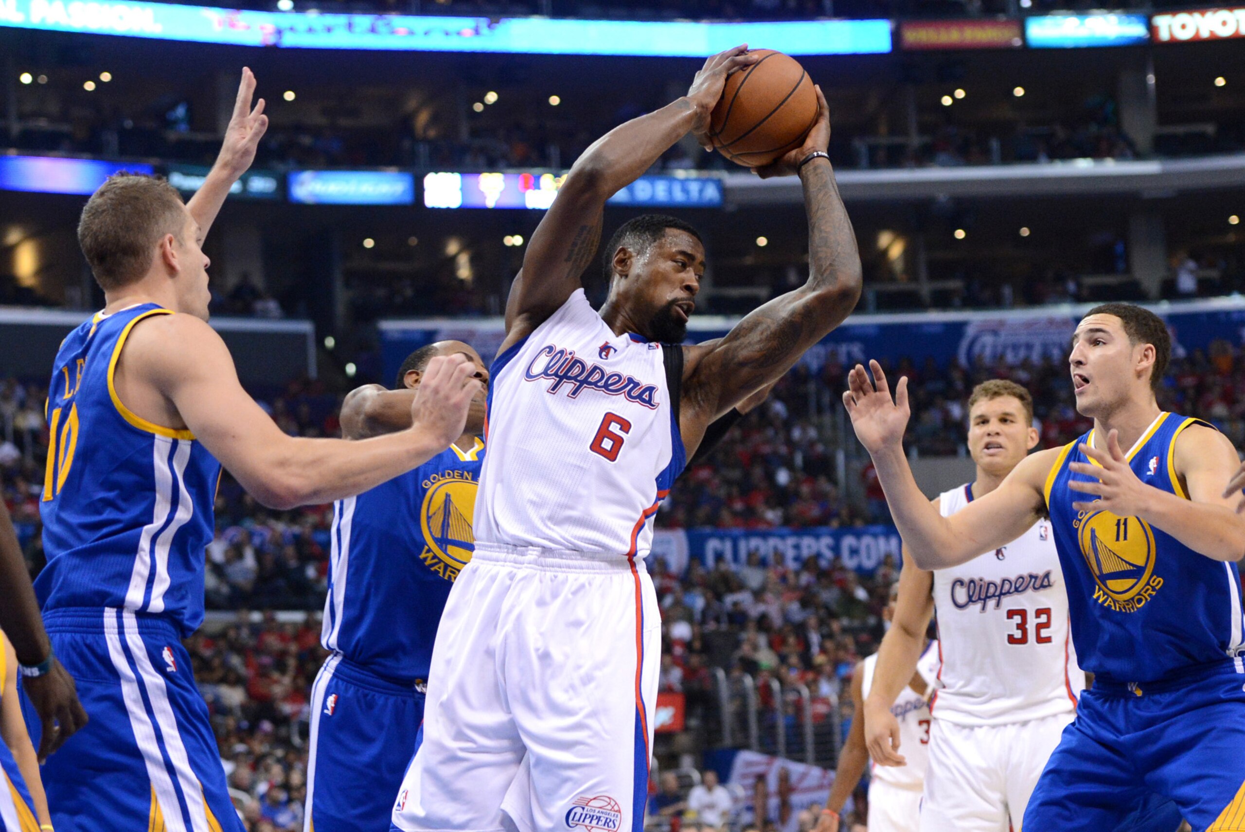 Oct 31, 2013; Los Angeles, CA, USA;   Golden State Warriors power forward David Lee (10), shooting guard Klay Thompson (11) and small forward Draymond Green (23) look on as Los Angeles Clippers center DeAndre Jordan (6) grabs a rebound in the second quart