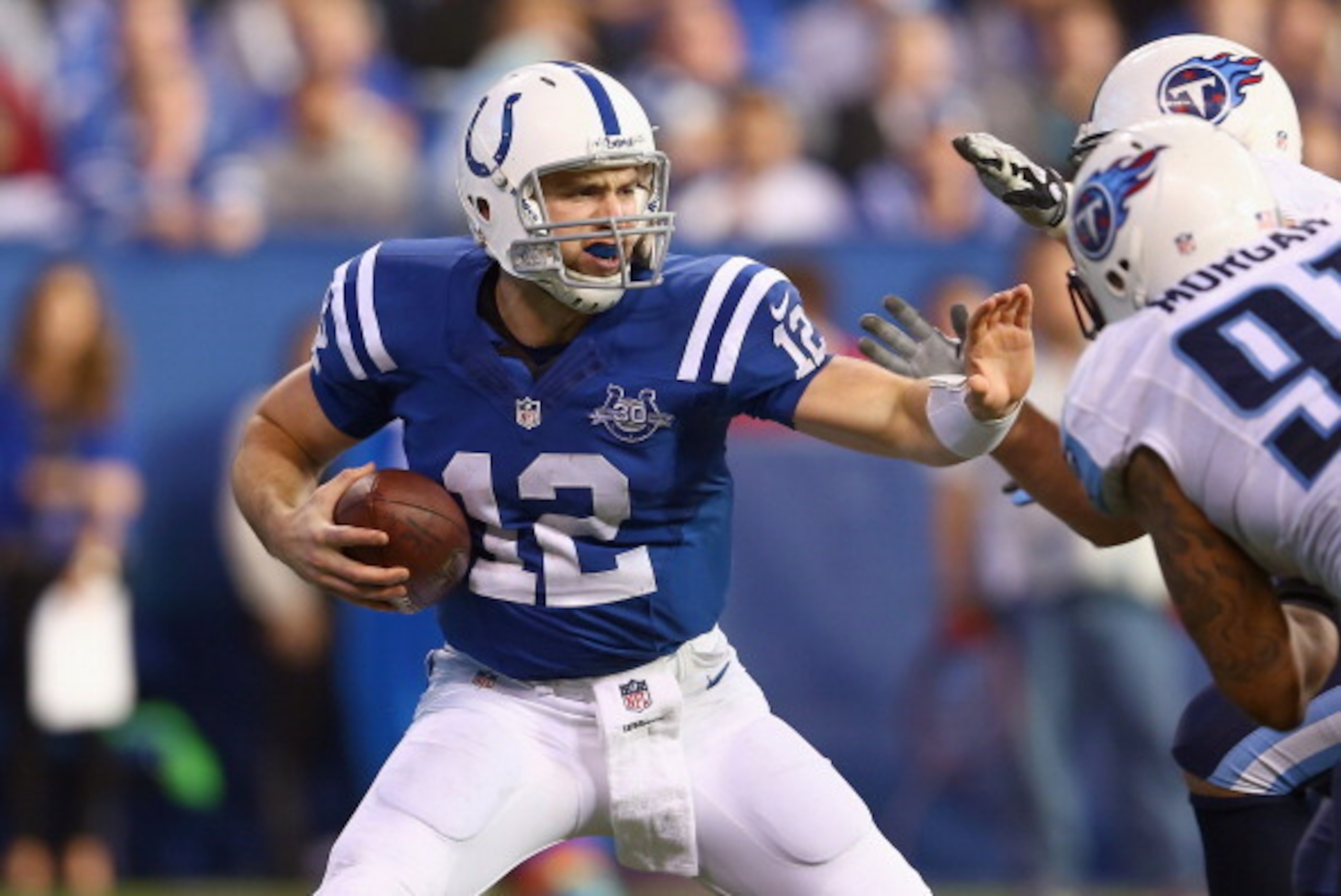 INDIANAPOLIS, IN - DECEMBER 01:  Andrew Luck #12  of the Indianapolis Colts runs with the ball during the NFL game against the Tennessee Titans at Lucas Oil Stadium on December 1, 2013 in Indianapolis, Indiana.  (Photo by Andy Lyons/Getty Images)