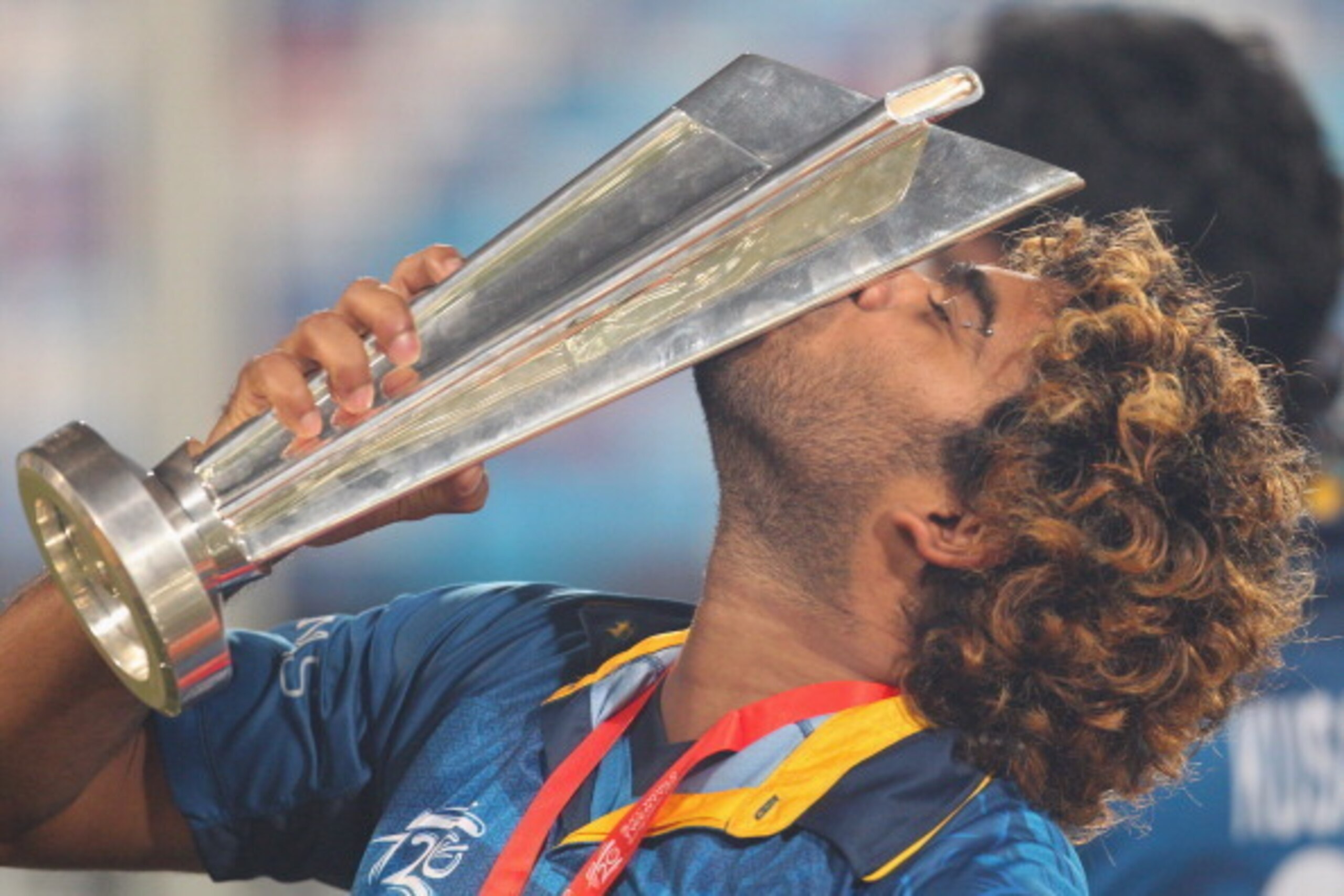 DHAKA, BANGLADESH - APRIL 06:  Lasith Malinga of Sri Lanka kisses the trophy after winning the Final of the ICC World Twenty20 Bangladesh 2014 between India and Sri Lanka at Sher-e-Bangla Mirpur Stadium on April 4, 2014 in Dhaka, Bangladesh.  (Photo by Sc
