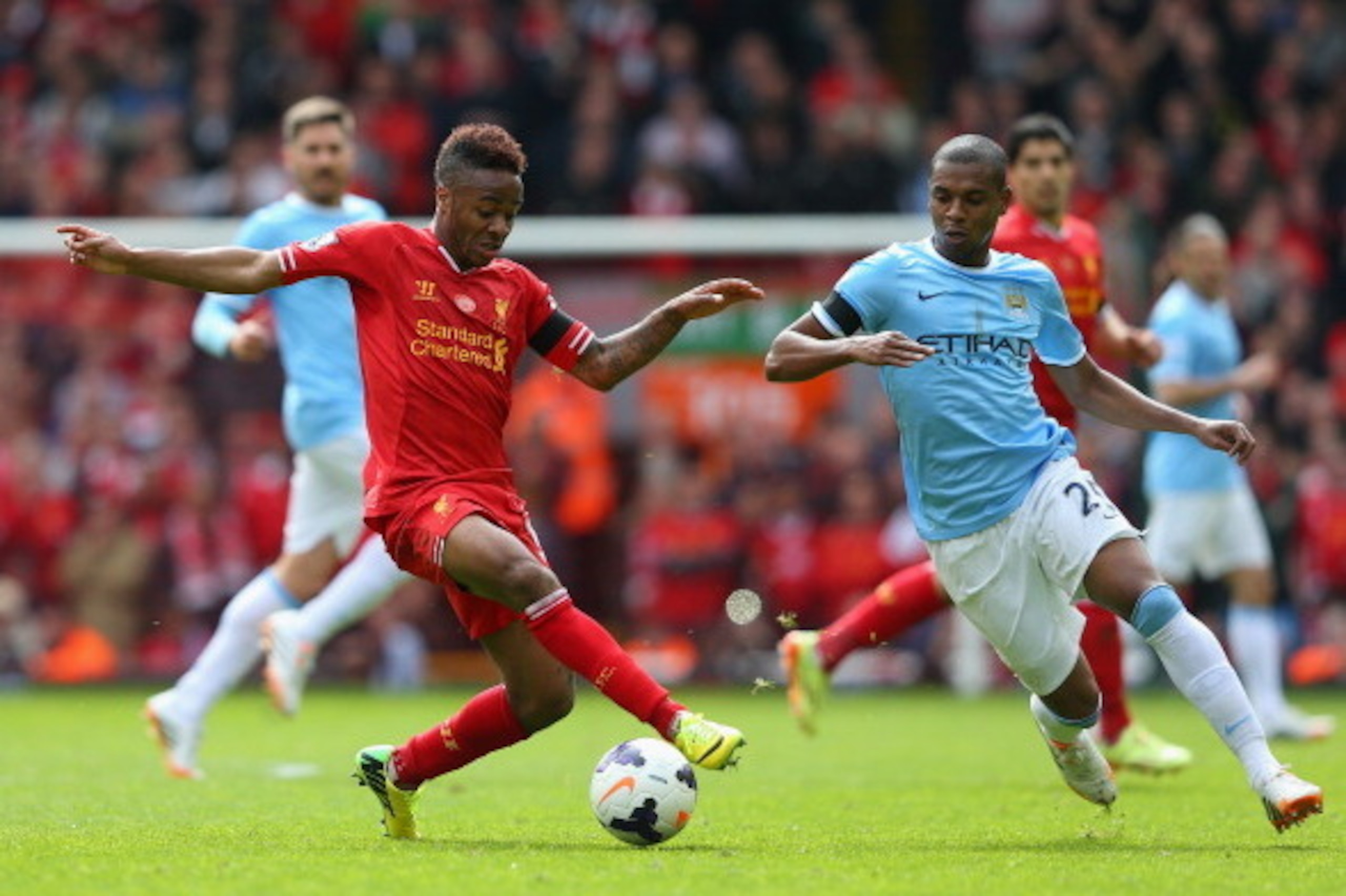 LIVERPOOL, ENGLAND - APRIL 13:  Raheem Sterling of Liverpool competes with Fernandinho of Manchester City during the Barclays Premier League match between Liverpool and Manchester City at Anfield on April 13, 2014 in Liverpool, England.  (Photo by Alex Li