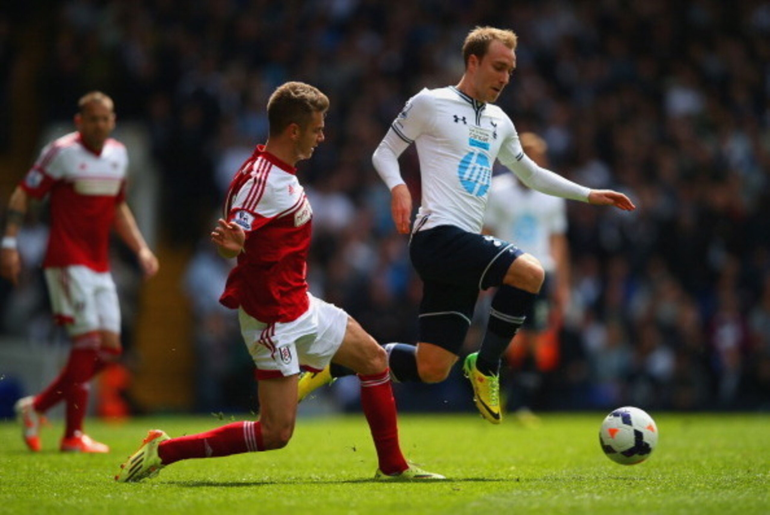 LONDON, ENGLAND - APRIL 19:  Alex Kacaniklic of Fulham tackles Christian Eriksen of Tottenham Hotspur  during the Barclays Premier League match between Tottenham Hotspur and Fulham at White Hart Lane on April 19, 2014 in London, England.  (Photo by Clive 