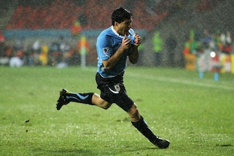 PORT ELIZABETH, SOUTH AFRICA - JUNE 26:  Luis Suarez of Uruguay celebrates scoring his second goal in the driving rain during the 2010 FIFA World Cup South Africa Round of Sixteen match between Uruguay and South Korea at Nelson Mandela Bay Stadium on June