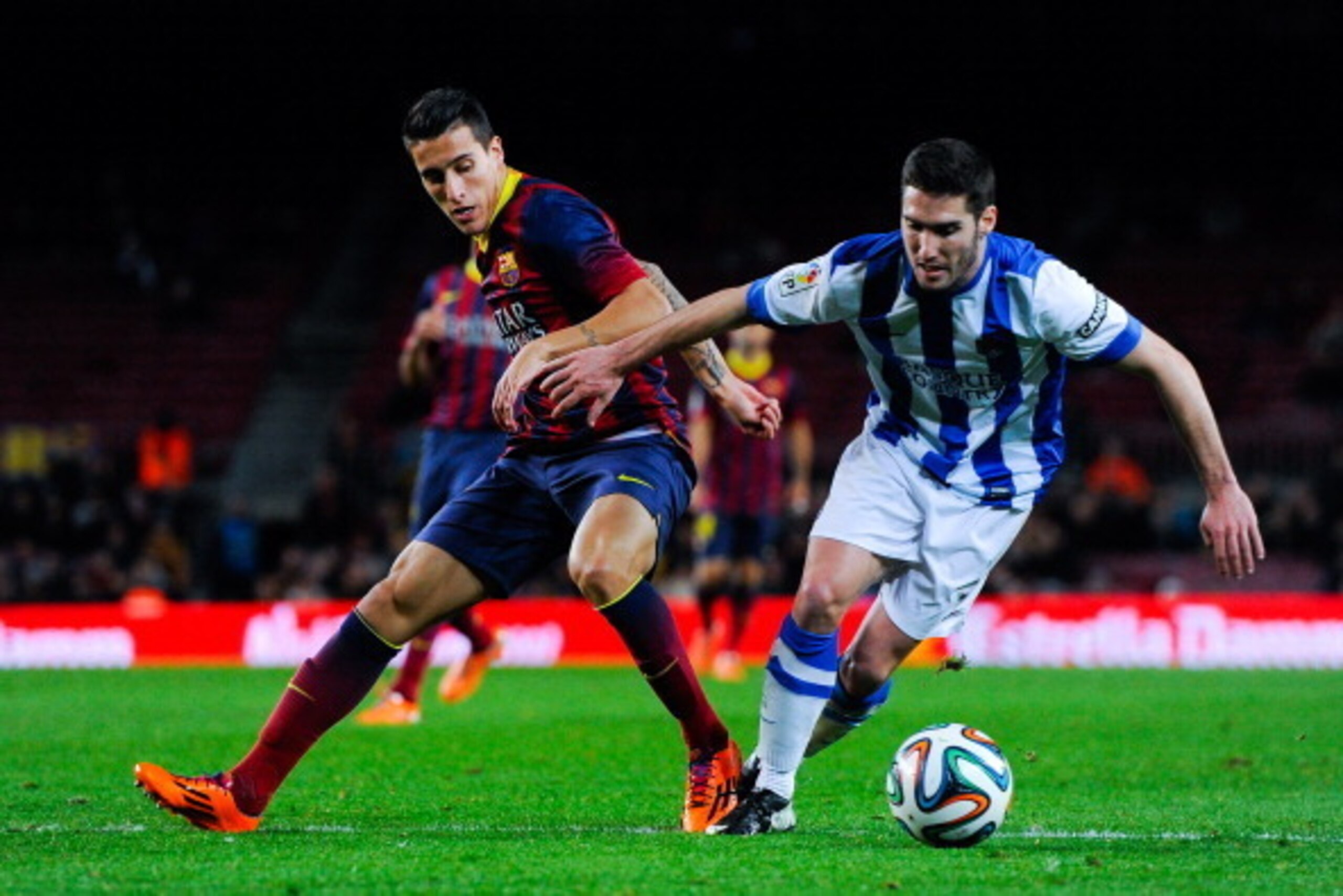 BARCELONA, SPAIN - FEBRUARY 05:  Cristian Tello of FC Barcelona duels for the ball with Zaldua of Real Sociedad during the Copa del Rey Semi-Final first leg match between Barcelona and Real Sociedad at Camp Nou on February 5, 2014 in Barcelona, Spain.  (P