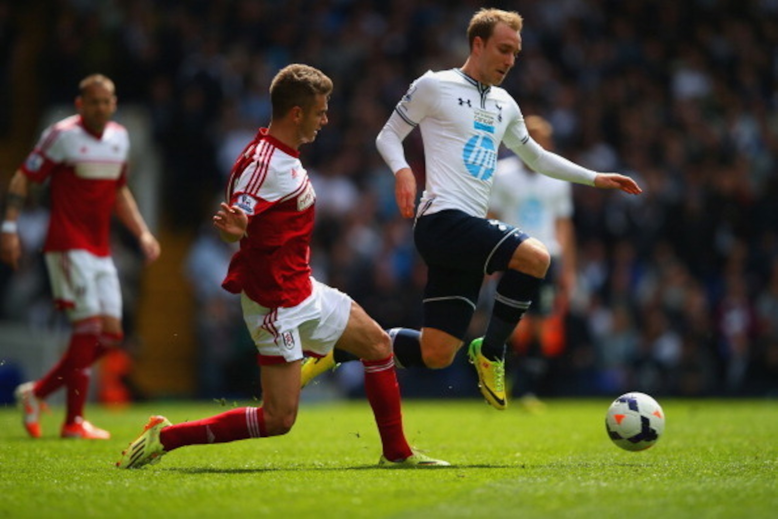 LONDON, ENGLAND - APRIL 19:  Alex Kacaniklic of Fulham tackles Christian Eriksen of Tottenham Hotspur  during the Barclays Premier League match between Tottenham Hotspur and Fulham at White Hart Lane on April 19, 2014 in London, England.  (Photo by Clive 