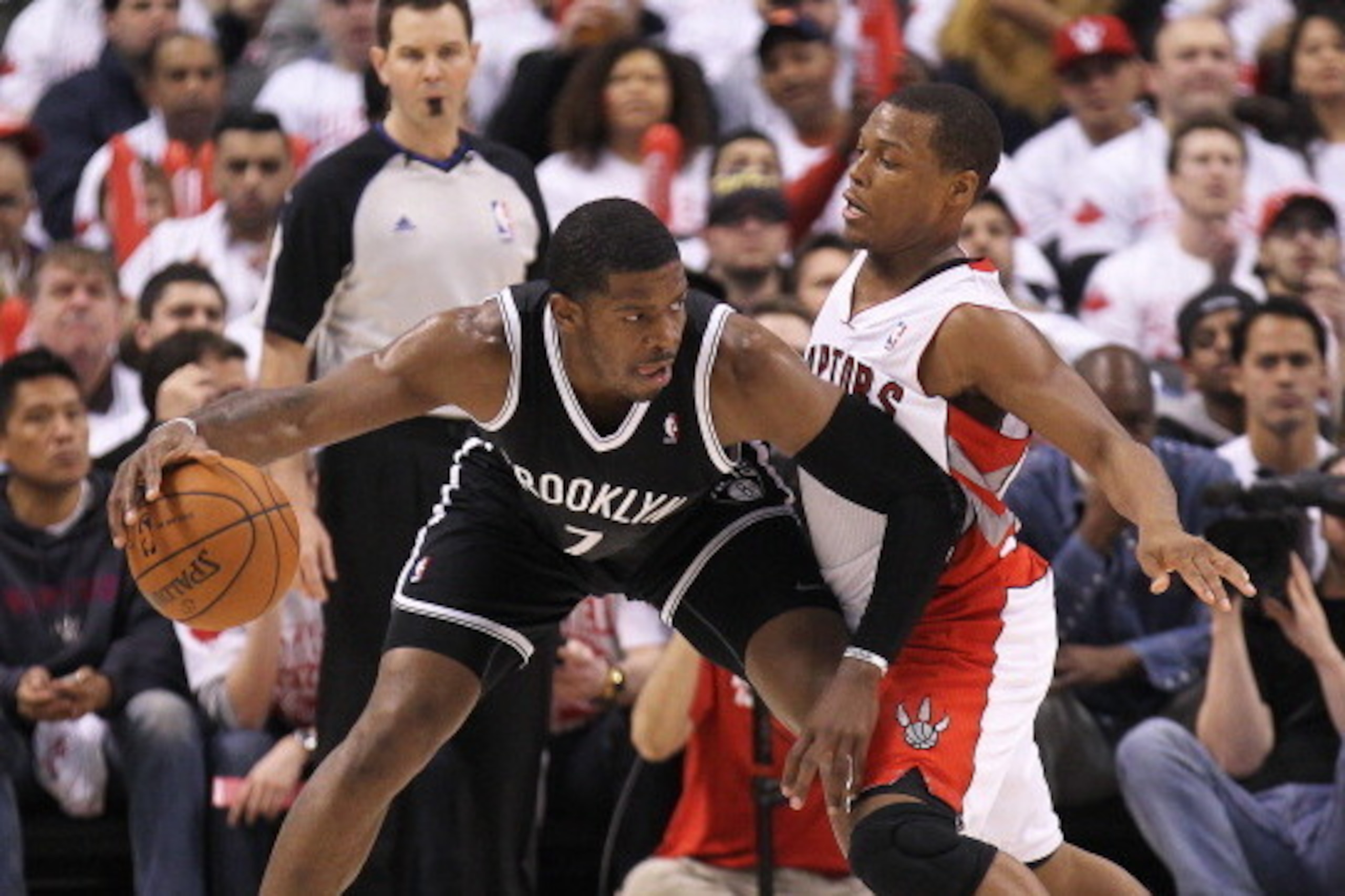TORONTO, ON - APRIL 19:  Joe Johnson #7 of the Brooklyn Nets plays against Kyle Lowry #7 of the Toronto Raptors in Game One of the NBA Eastern Conference play-off at the Air Canada Centre on April 19, 2014 in Toronto, Ontario, Canada. The Nets defeated th