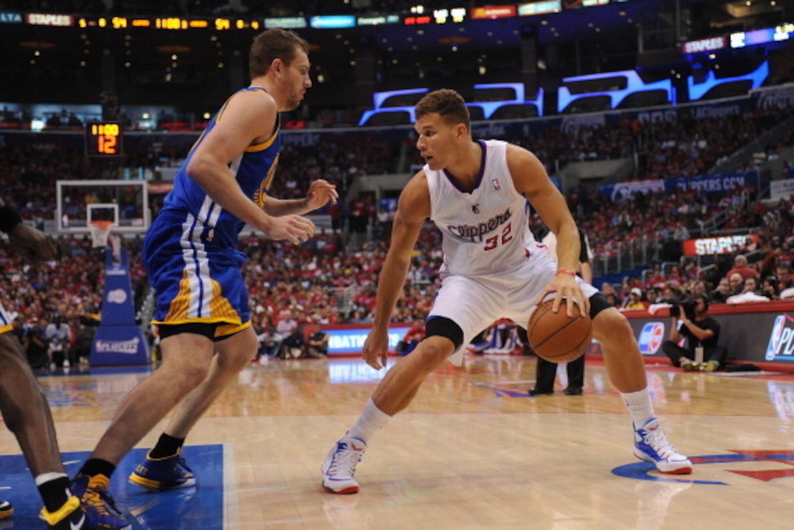 LOS ANGELES, CA - APRIL 19: Blake Griffin #32 of the Los Angeles Clippers handles the basketball against David Lee #10 of the Golden State Warriors during Game One of the Western Conference Quarterfinals of the NBA Playoffs at STAPLES Center on April 19, 