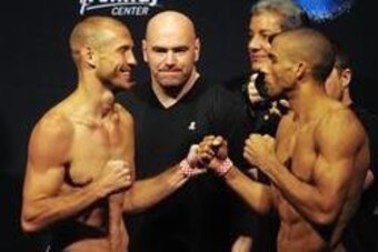 Apr 18, 2014; Orlando, FL, USA; Donald Cerrone (left) faces off with opponent Edson Barboza  in front of UCF president Dana White for their lightweight fight for UFC on FOX 11 at Amway Center. Mandatory Credit: David Manning-USA TODAY Sports