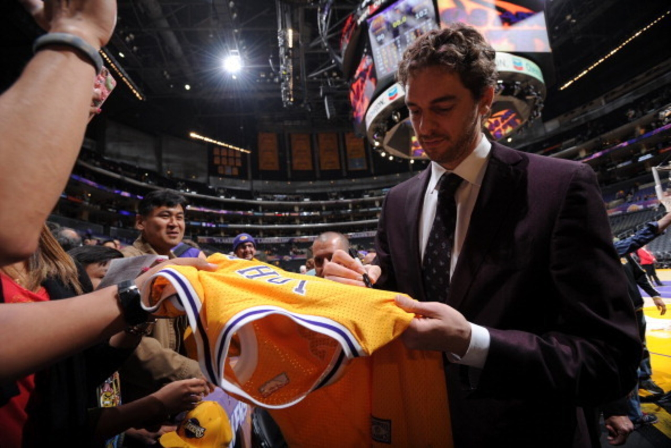 LOS ANGELES, CA - APRIL 13: Pau Gasol #16 of the Los Angeles Lakers signs autographs for fans after a game against the Memphis Grizzlies at Staples Center on April 13, 2014 in Los Angeles, California. NOTE TO USER: User expressly acknowledges and agrees t