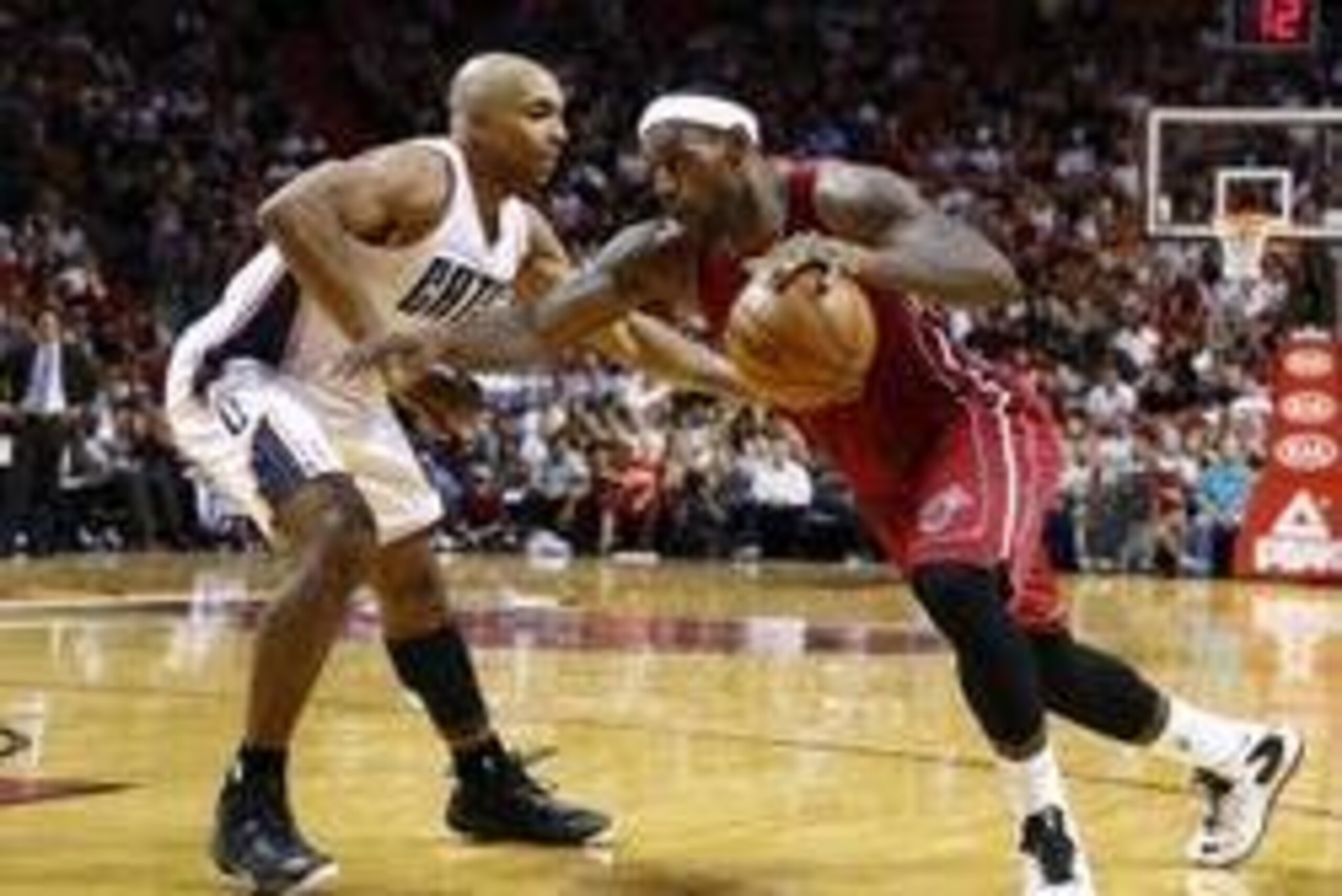 Dec 1, 2013; Miami, FL, USA; Miami Heat small forward LeBron James (6) is defended by Charlotte Bobcats shooting guard Gerald Henderson in the second half at American Airlines Arena. The Heat won 99-98. Mandatory Credit: Robert Mayer-USA TODAY Sports