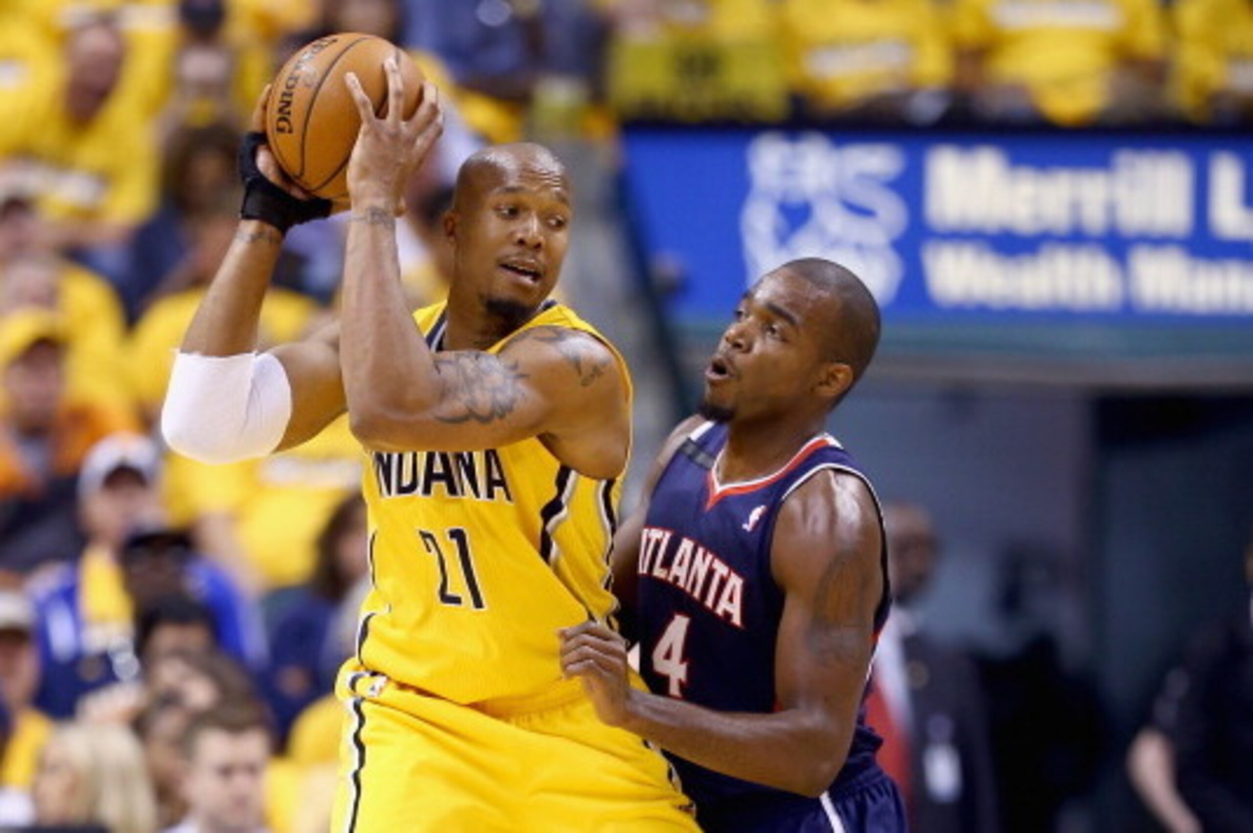 INDIANAPOLIS, IN - APRIL 19:  Paul Milsap #4 of the Atllanta Hawks defends David West #21 of the Indiana Pacers in Game 1 of the Eastern Conference Quarterfinals during the 2014 NBA Playoffs at Bankers Life Fieldhouse on April 19, 2014 in Indianapolis, In