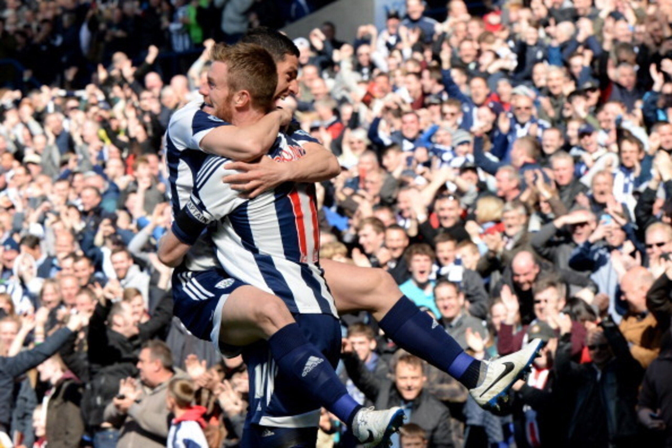 WEST BROMWICH, ENGLAND - APRIL 12: Chris Brunt and Graham Dorrans of West Brom celebrate after the second goal during the Premier League match between West Bromwich Albion and Tottenham Hotspur at The Hawthorns on April 12, 2014 in West Bromwich, England.