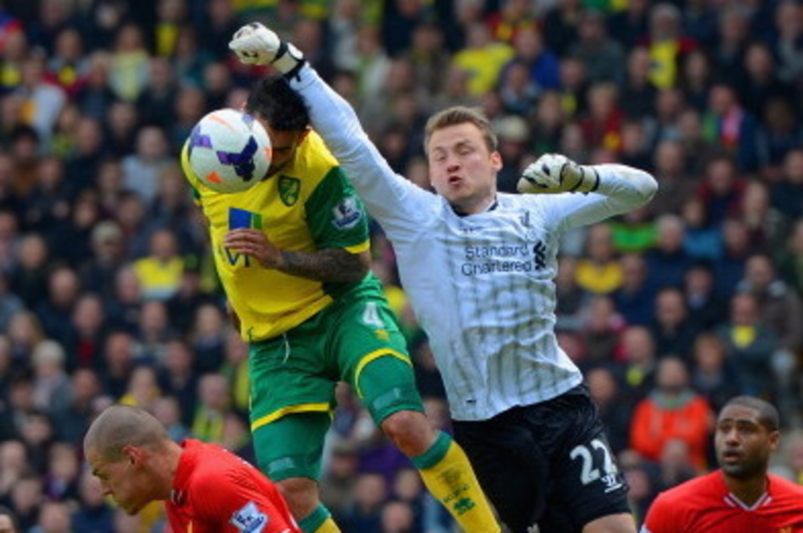 NORWICH, ENGLAND - APRIL 20:  Simon Mignolet of Liverpool fails to punch the ball clear during the Barclays Premier League match between Norwich City and Liverpool at Carrow Road on April 20, 2014 in Norwich, England.  (Photo by Michael Regan/Getty Images