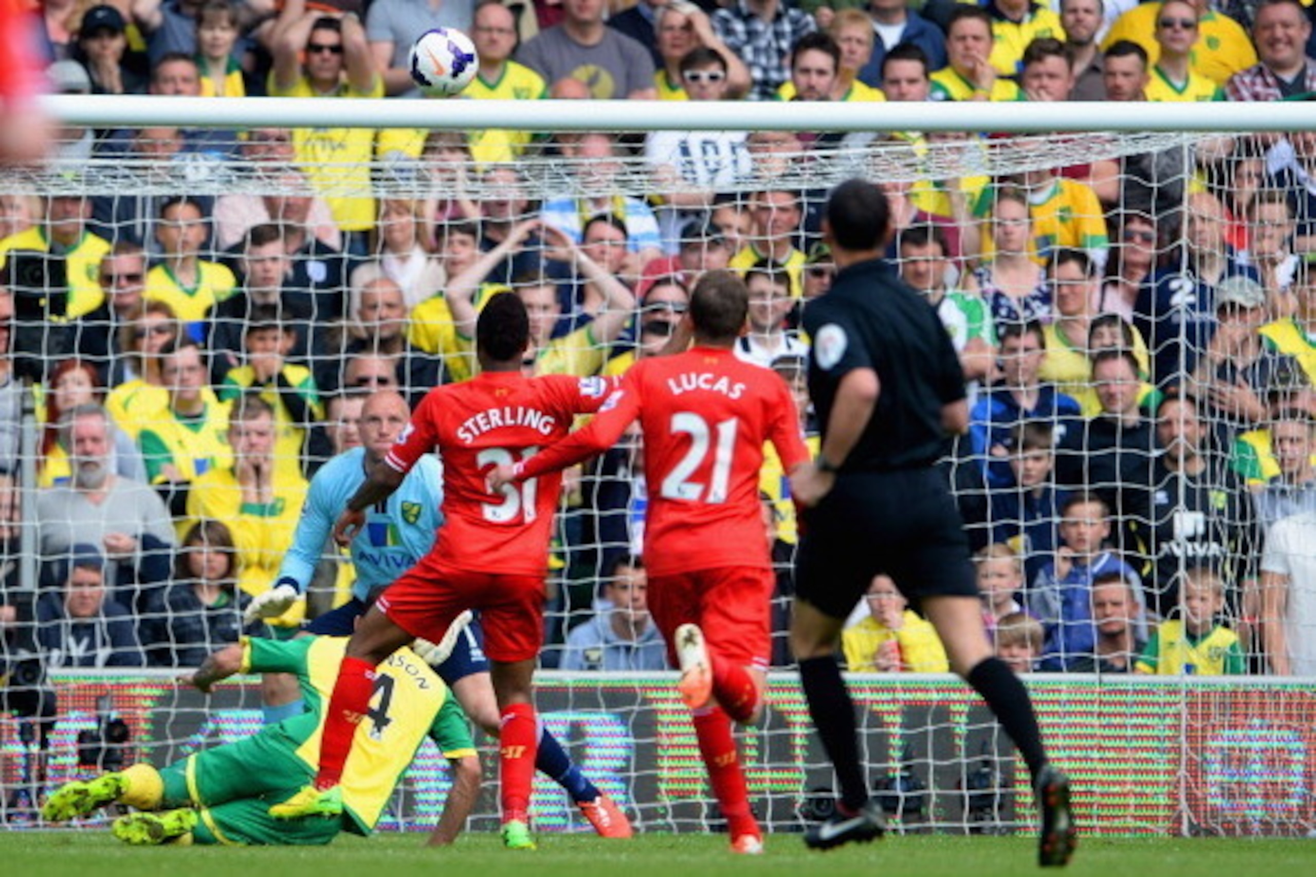 NORWICH, ENGLAND - APRIL 20:  Raheem Sterling of Liverpool scores their third goal during the Barclays Premier League match between Norwich City and Liverpool at Carrow Road on April 20, 2014 in Norwich, England.  (Photo by Michael Regan/Getty Images)
