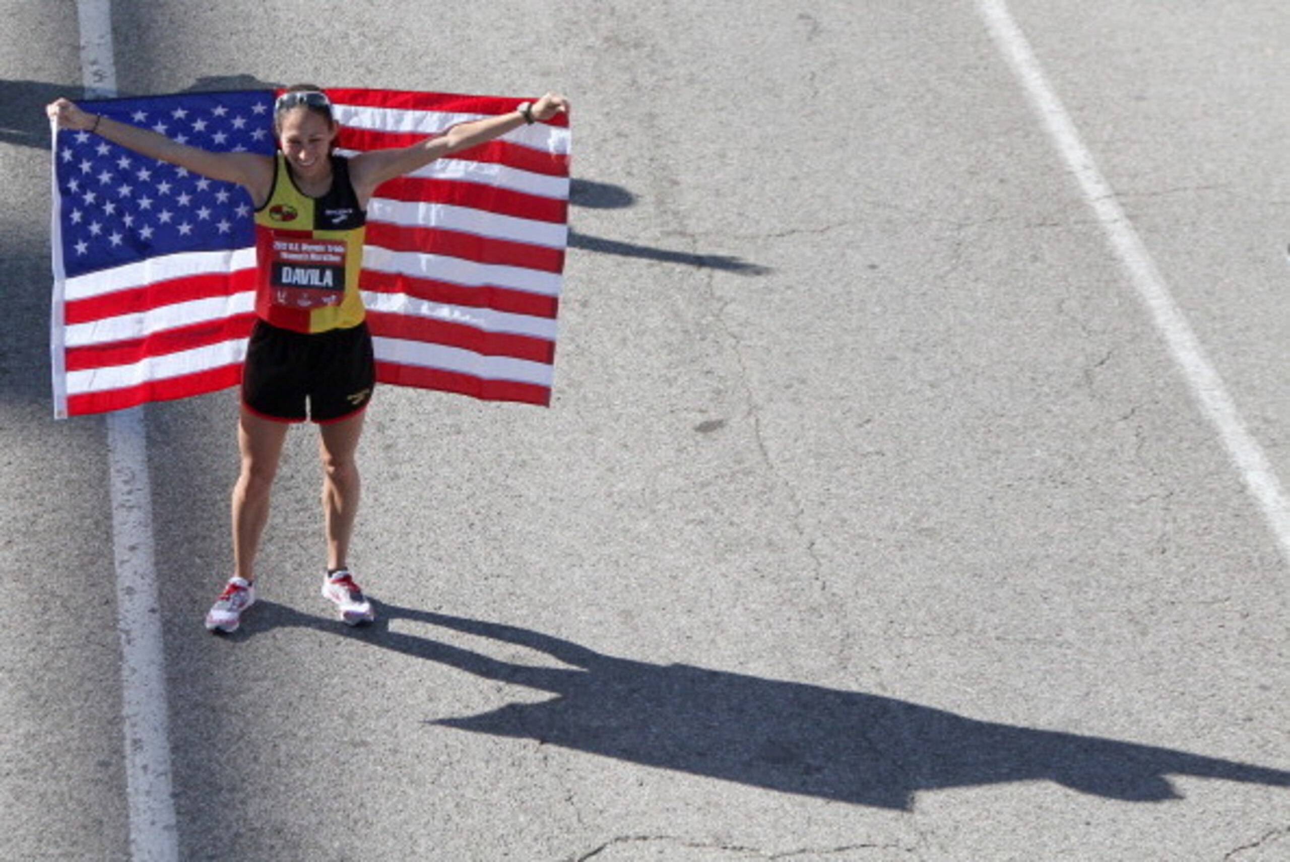 HOUSTON, TX - JANUARY 14:  Desiree Davila, who finished with a time of 2:25:55, holds an American flag after the U.S. Marathon Olympic Trials January 14, 2012 in Houston, Texas. (Photo by Thomas B. Shea/Getty Images)