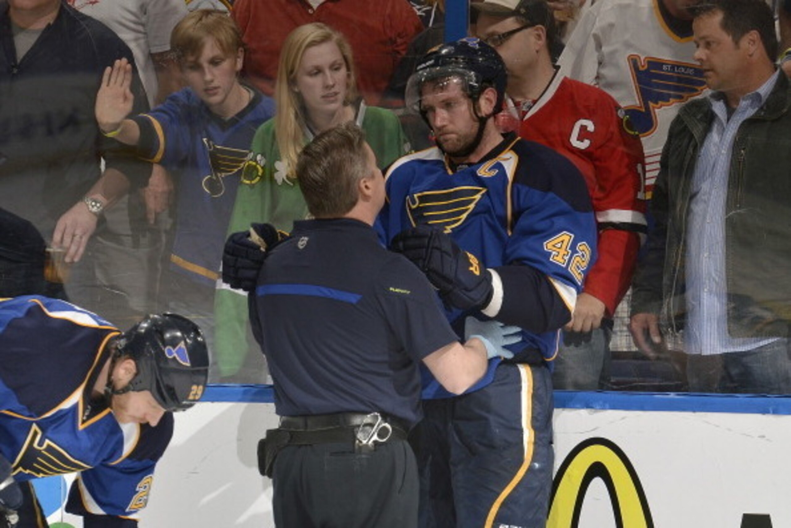 ST. LOUIS, MO - APRIL 19: David Backes #42 of the St. Louis Blues is checked out by trainer Ray Barile after being checked into the boards by Brent Seabrook #7 of the Chicago Blackhawks in Game Two of the First Round of the 2014 Stanley Cup Playoffs at th