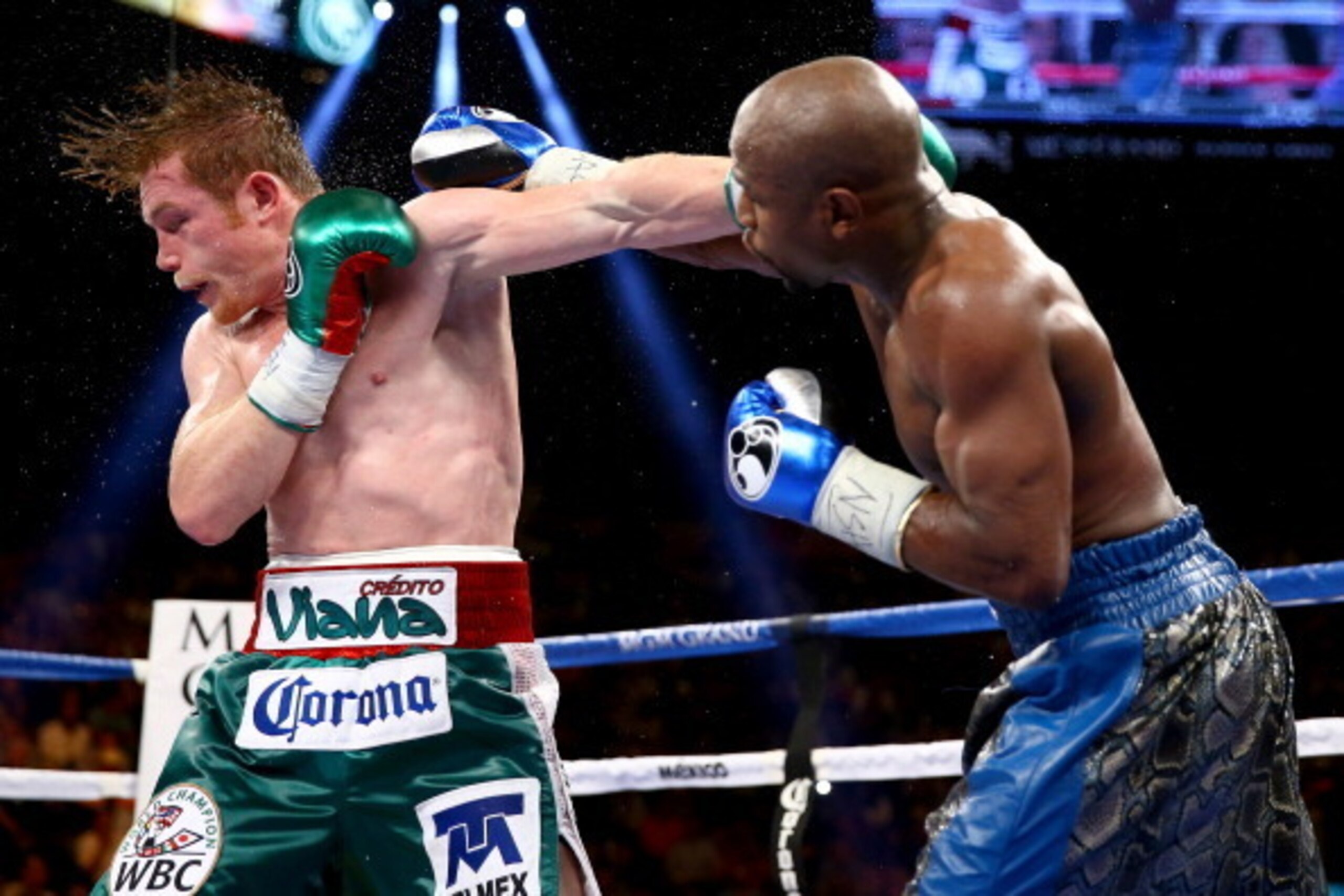 LAS VEGAS, NV - SEPTEMBER 14:  (R-L) Floyd Mayweather Jr. throws a right to the head of Canelo Alvarez during their WBC/WBA 154-pound title fight at the MGM Grand Garden Arena on September 14, 2013 in Las Vegas, Nevada.  (Photo by Al Bello/Getty Images)