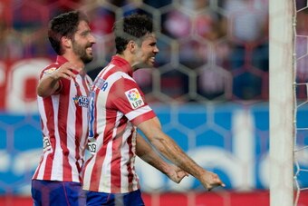 MADRID, SPAIN - APRIL 18:  Diego Costa (R) of Atletico de Madrid celebrates scoring their second goal with teammate Raul Garcia (L) during the La Liga match between Club Atletico de Madrid and Elche FC at Vicente Calderon Stadium on April 18, 2014 in Madr