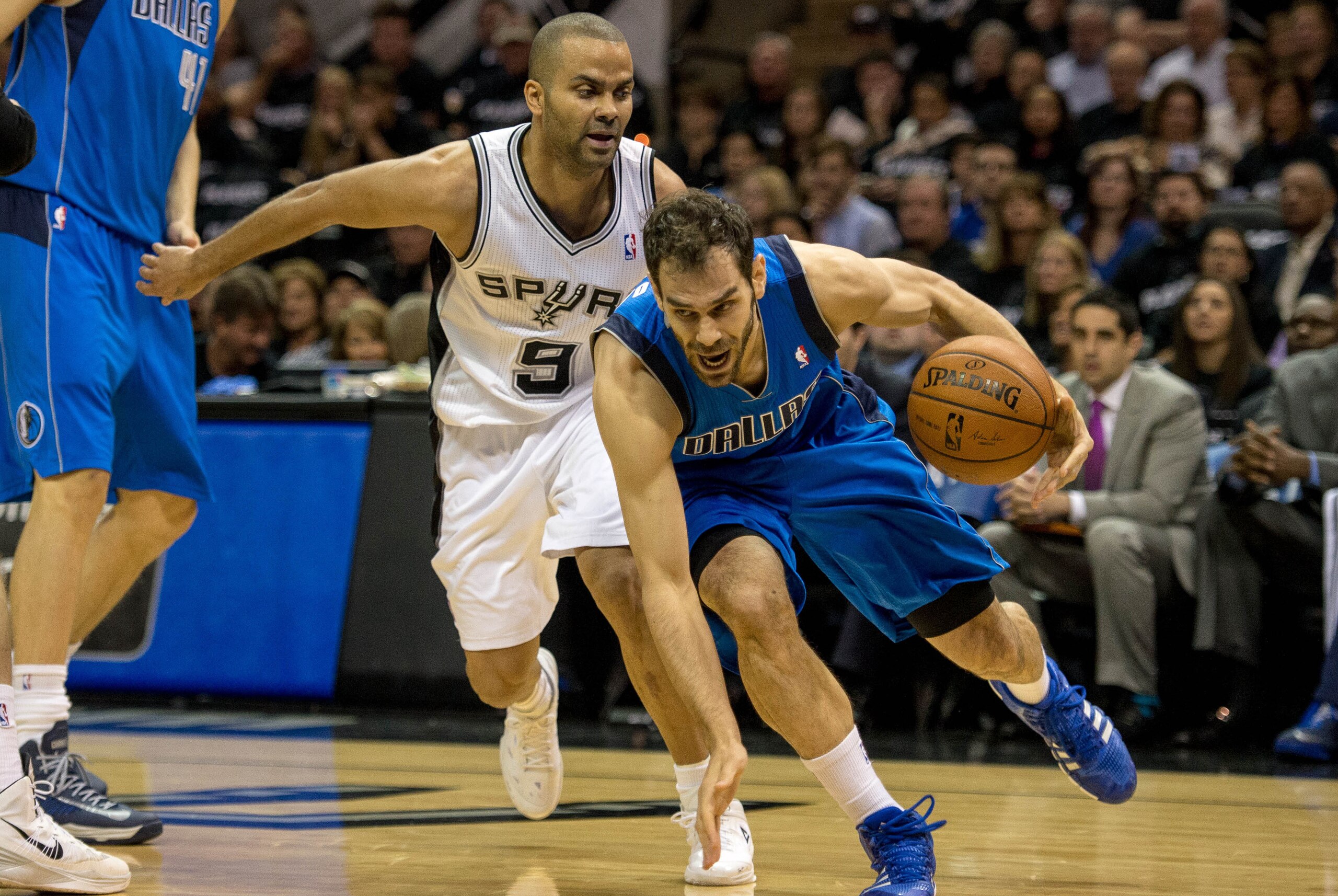 Apr 20, 2014; San Antonio, TX, USA; Dallas Mavericks guard Jose Calderon (8) drives to the basket past San Antonio Spurs guard Tony Parker (9) during the first quarter in game one during the first round of the 2014 NBA Playoffs at AT&T Center. Mandatory C