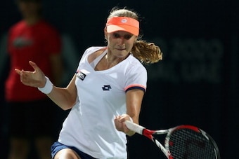 DUBAI, UNITED ARAB EMIRATES - FEBRUARY 18:  Ekaterina Makarova of Russia in action against  Serena Williams of the USA during day two of the WTA Dubai Duty Free Tennis Championship at the Dubai Tennis Stadium  on February 18, 2014 in Dubai, United Arab Em