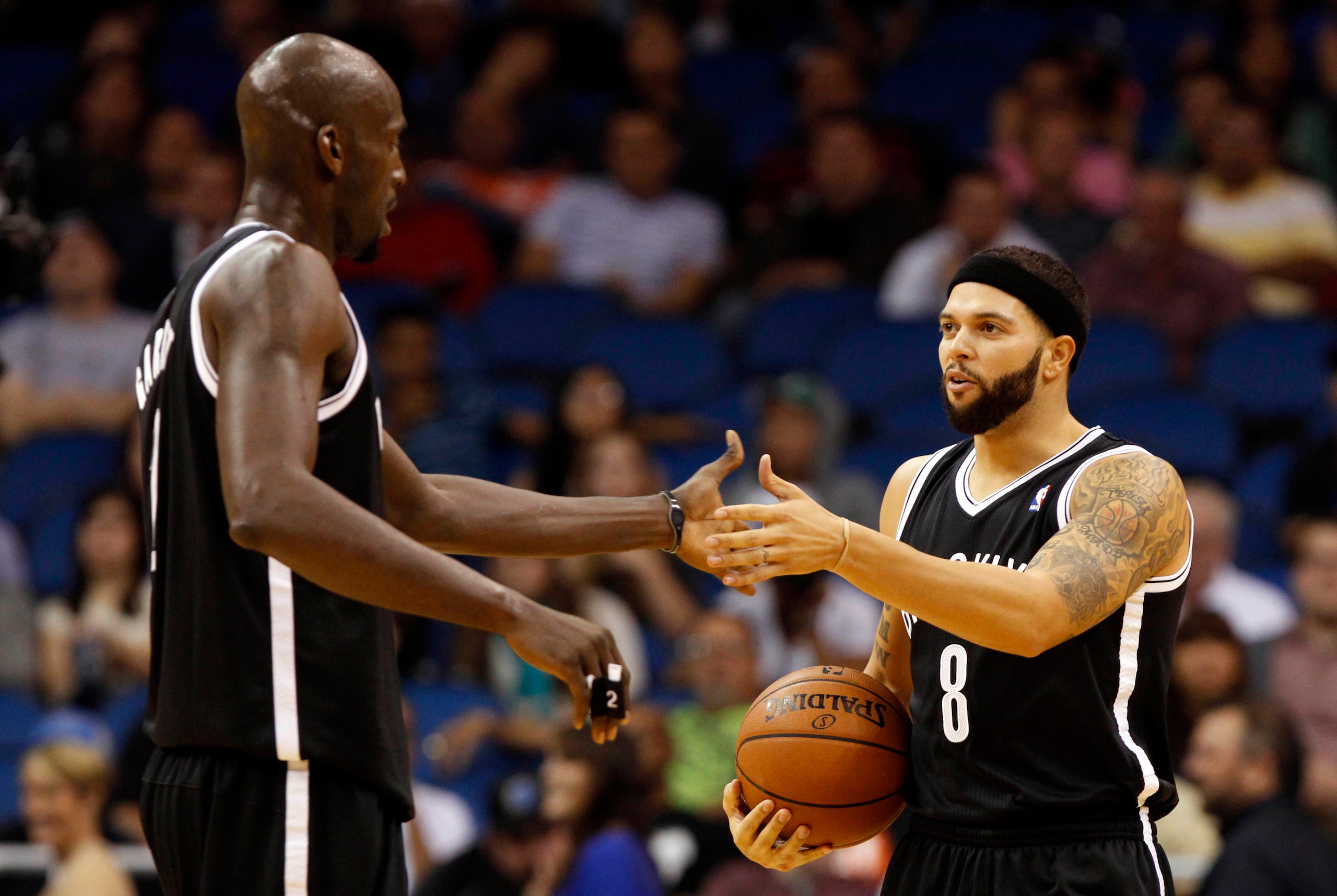Nov 3, 2013; Orlando, FL, USA; Brooklyn Nets point guard Deron Williams (8) and power forward Kevin Garnett (2) high five against the Orlando Magic during the second quarter at Amway Center. Mandatory Credit: Kim Klement-USA TODAY Sports