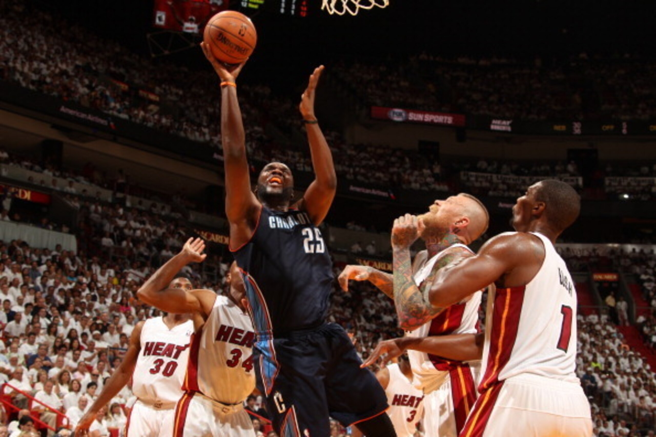 MIAMI, FL - April 20: Al Jefferson #25 of the Charlotte Bobcats goes up for a shot against the Miami Heat during Game One of the Eastern Conference Quarterfinals of the 2014 NBA playoffs at the American Airlines Arena in Miami, Florida on April 20, 2014. 