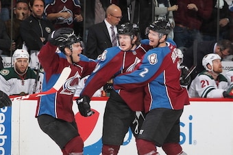 DENVER, CO - APRIL 19:  Nathan MacKinnon #29 of the Colorado Avalanche is congratulated by teammates Paul Stastny #26 and Nick Holden #2 after scoring his first career playoff goal against the Minnesota Wild in Game Two of the First Round of the 2014 Stan