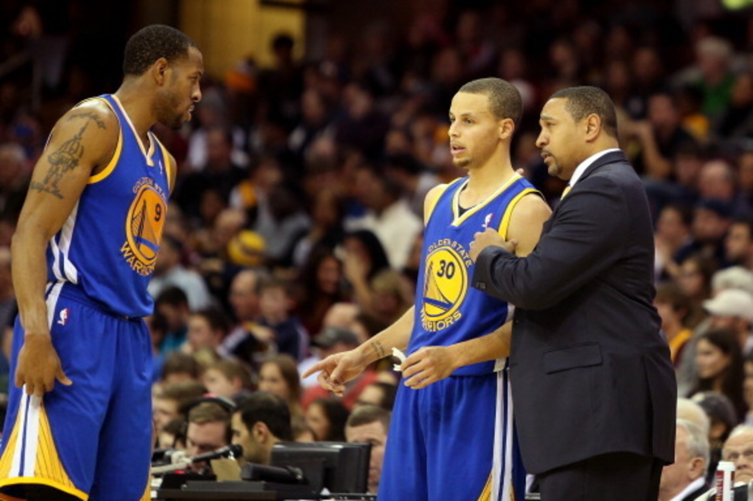 CLEVELAND, OH - DECEMBER 29: Head coach Mark Jackson of the Golden State Warriors speaks to Andre Iguodala #9 and Stephen Curry #30 of the Golden State Warriors in the fourth quarter against the Cleveland Cavaliers at Quicken Loans Arena on December 29, 2