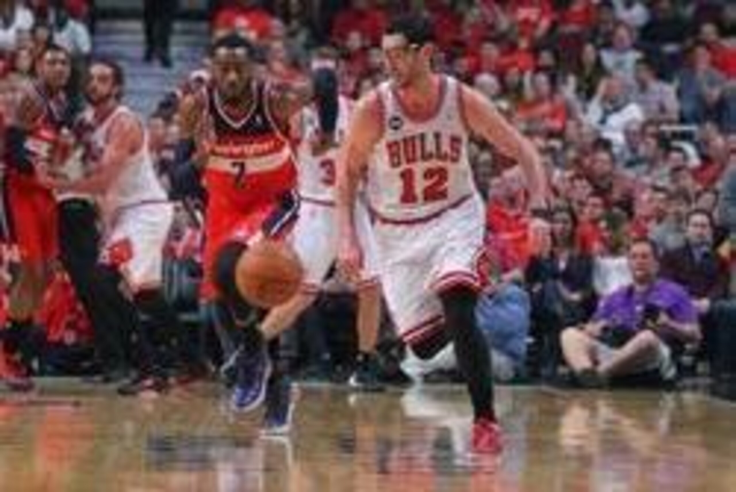 Apr 20, 2014; Chicago, IL, USA; Chicago Bulls guard Kirk Hinrich (12) and Washington Wizards guard John Wall (2) chase down the ball during the first quarter of game one of the first round of the 2014 NBA Playoffs at the United Center. Mandatory Credit: D