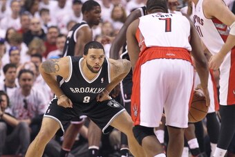 TORONTO, ON - APRIL 19:  Deron Williams #8 of the Brooklyn Nets defends against Kyle Lowry #7 of the Toronto Raptors in Game One of the NBA Eastern Conference play-off at the Air Canada Centre on April 19, 2014 in Toronto, Ontario, Canada. The Nets defeat