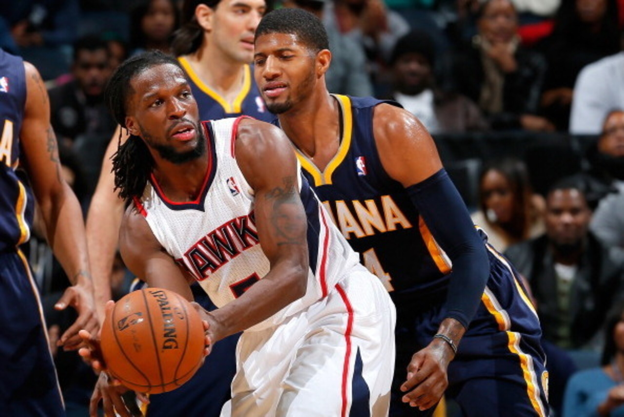 ATLANTA, GA - JANUARY 08:  Paul George #24 of the Indiana Pacers defends against DeMarre Carroll #5 of the Atlanta Hawks at Philips Arena on January 8, 2014 in Atlanta, Georgia.  NOTE TO USER: User expressly acknowledges and agrees that, by downloading an