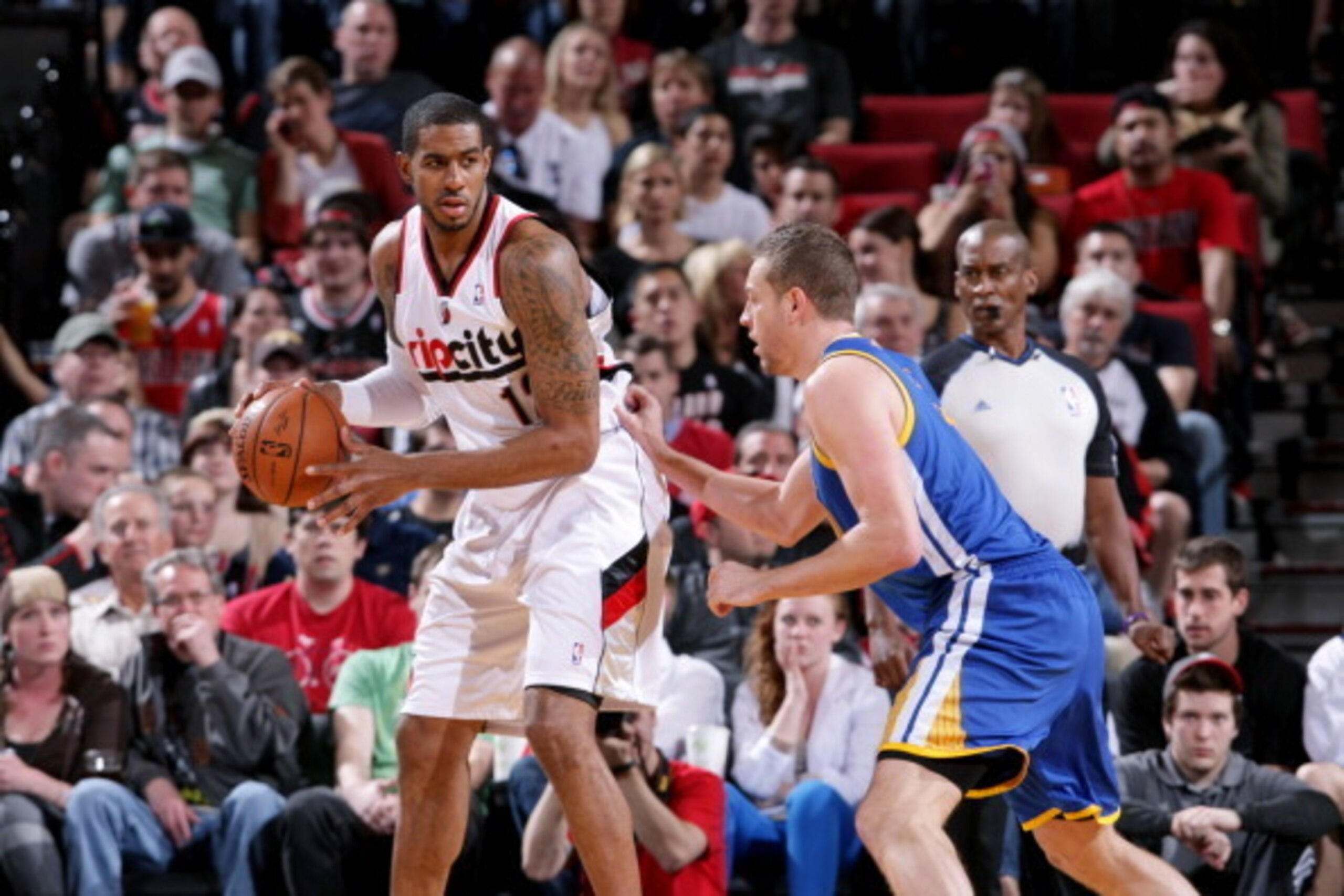 PORTLAND, OR - APRIL 13: LaMarcus Aldridge #12 of the Portland Trail Blazers handles the ball against David Lee #10 of the Golden State Warriors on April 13, 2014 at the Moda Center Arena in Portland, Oregon. NOTE TO USER: User expressly acknowledges and 