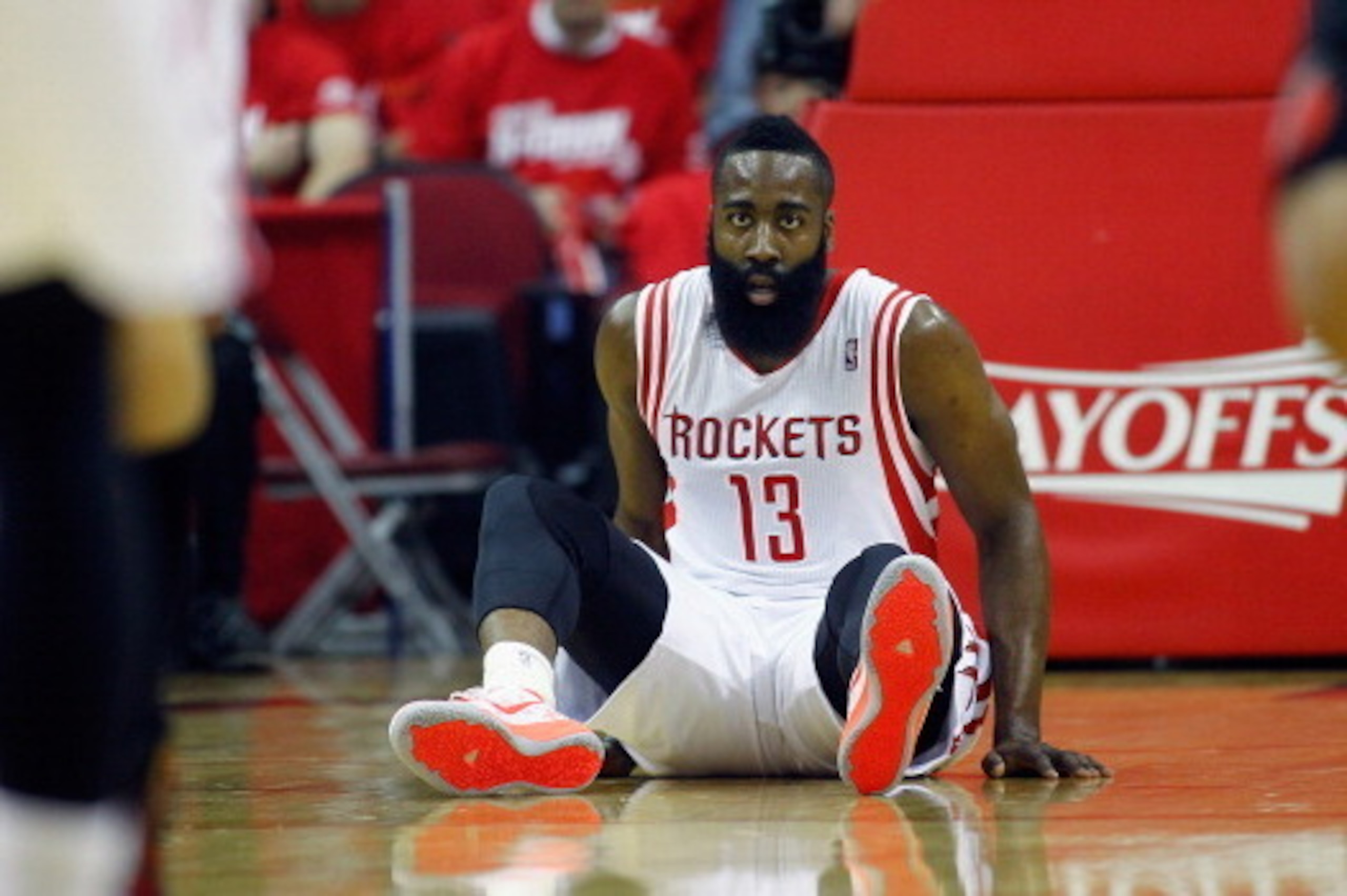 HOUSTON, TX - APRIL 20:  James Harden #13 of the Houston Rockets falls to the floor during game action in Game One of the Western Conference Quarterfinals during the 2014 NBA Playoffs at the Toyota Center on April 20, 2014 in Houston, Texas. NOTE TO USER: