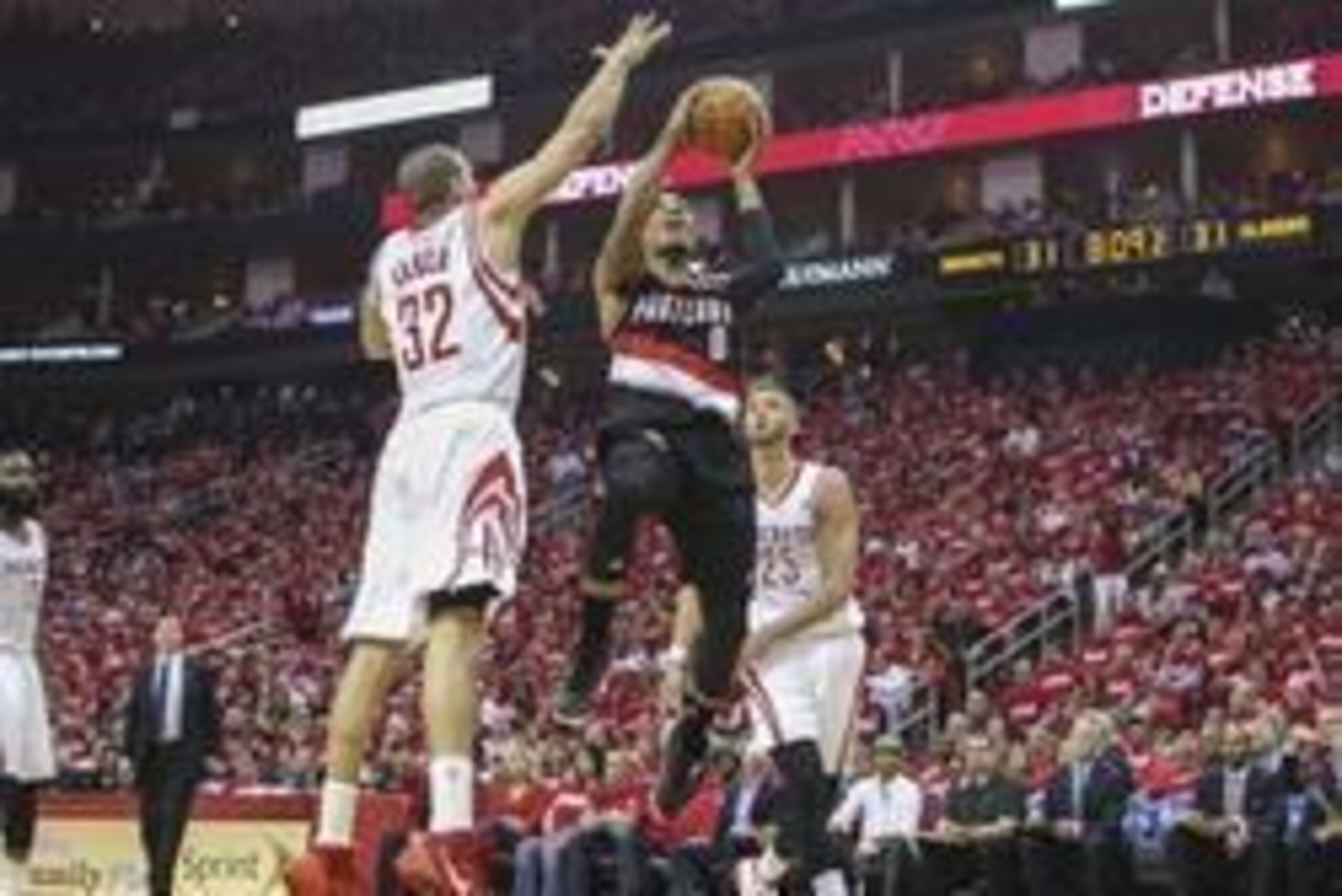 Apr 20, 2014; Houston, TX, USA; Portland Trail Blazers guard Damian Lillard (0) shoots the ball as Houston Rockets guard Francisco Garcia (32) defends during the second quarter in game one during the first round of the 2014 NBA Playoffs at Toyota Center. 