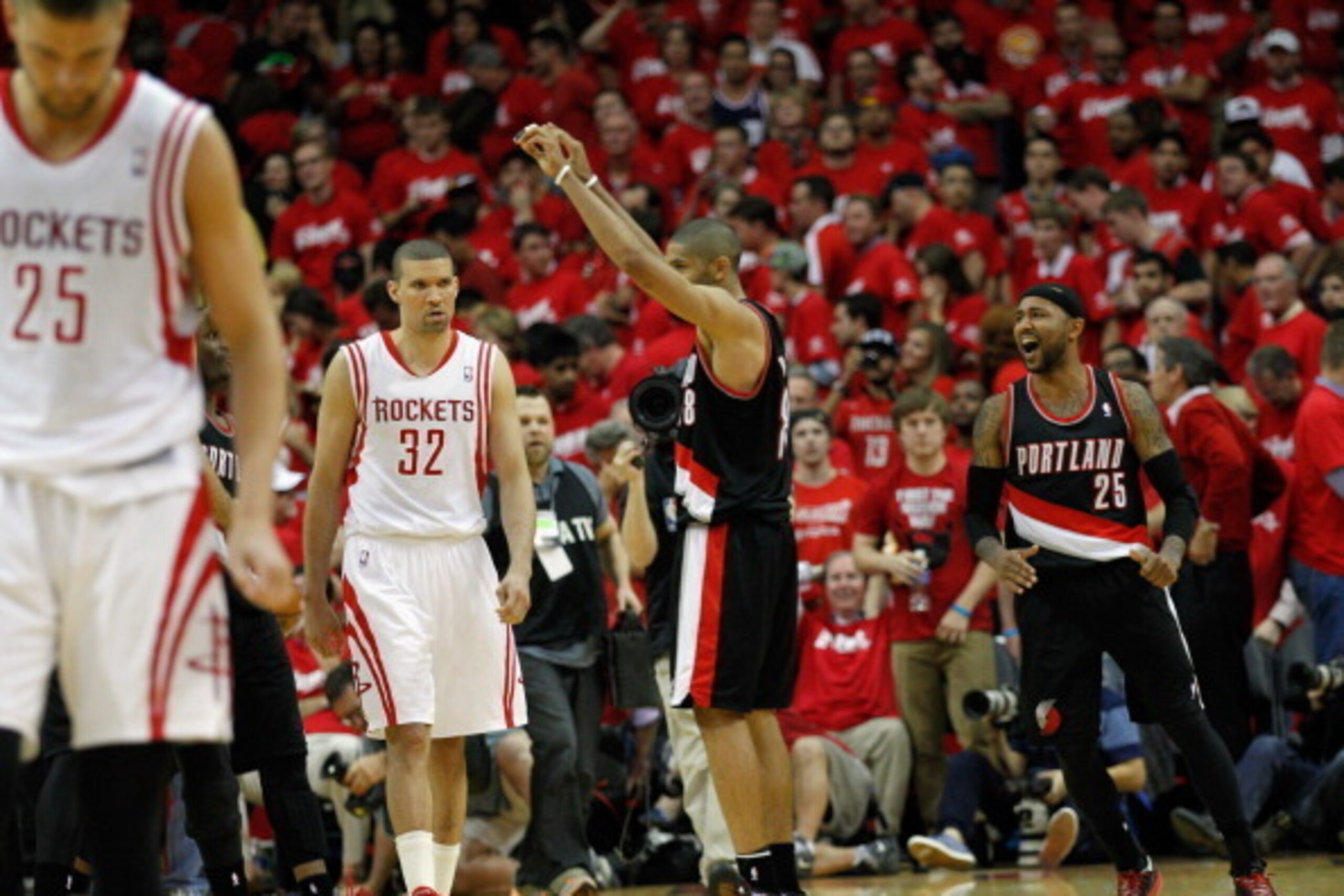 HOUSTON, TX - APRIL 20:  Mo Williams #25 of the Portland Trail Blazers and Nicolas Batum #88 celebrate their overtime win as Francisco Garcia #32 of the Houston Rockets and Chandler Parsons #25 walk off the court in Game One of the Western Conference Quar