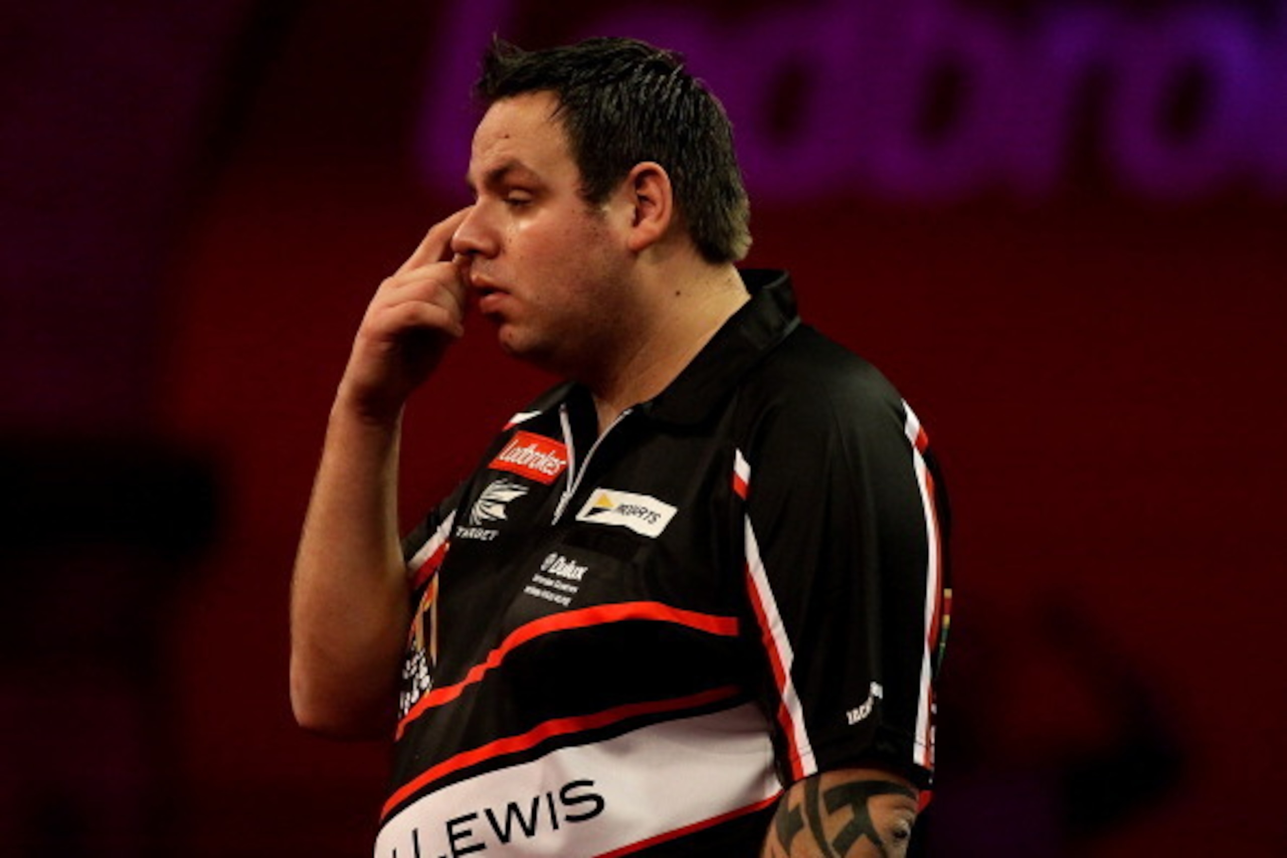LONDON, ENGLAND - DECEMBER 30: Adrian Lewis of England reacts during his semi final match against Michael van Gerwen of The Netherlands on day fifteen of the Ladbrokes.com World Darts Championship at Alexandra Palace on December 30, 2013 in London, Englan