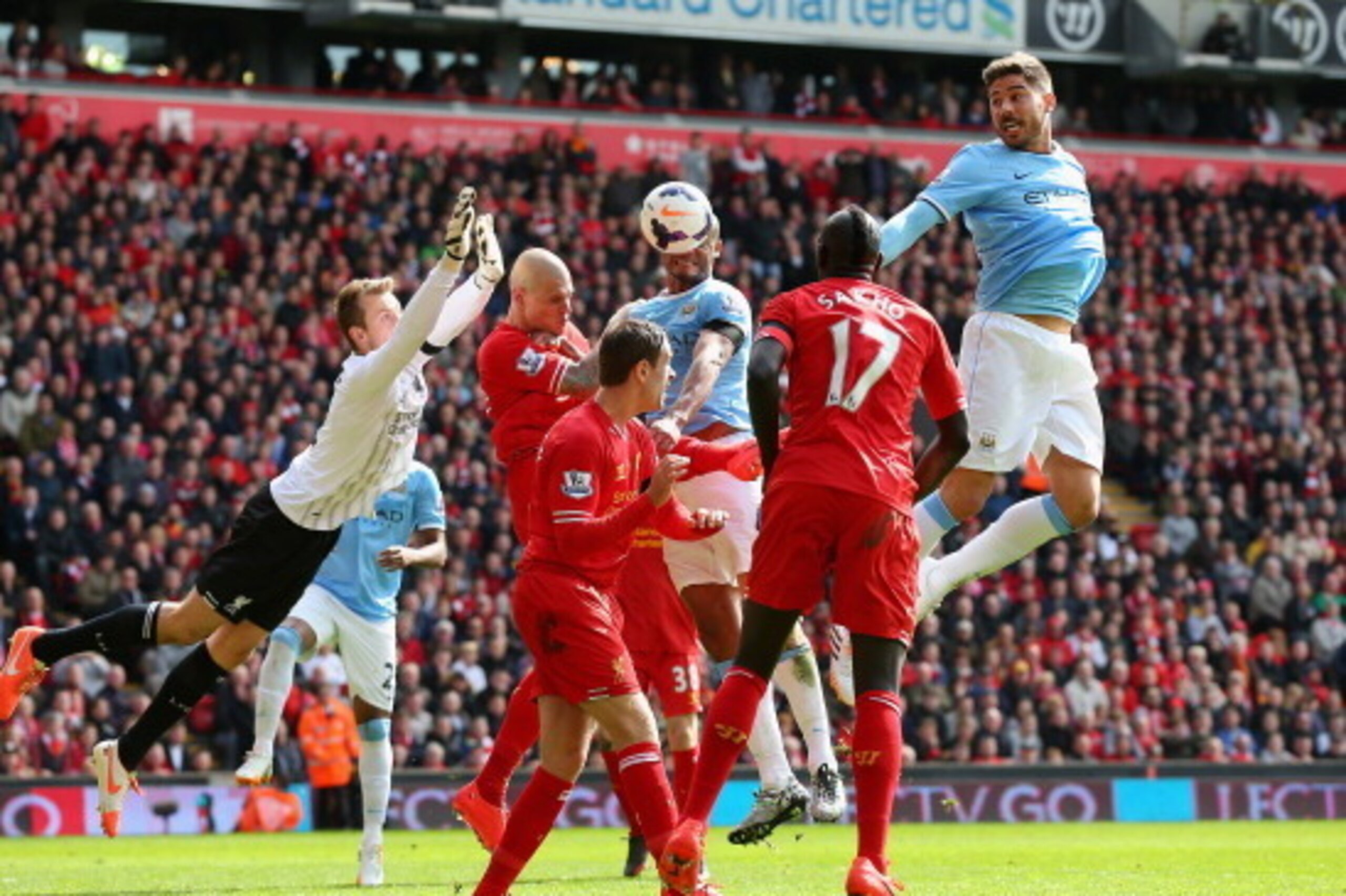 LIVERPOOL, ENGLAND - APRIL 13:  Javi Garcia of Manchester City heads at goal past the dive of Simon Mignolet of Liverpool during the Barclays Premier League match between Liverpool and Manchester City at Anfield on April 13, 2014 in Liverpool, England.  (