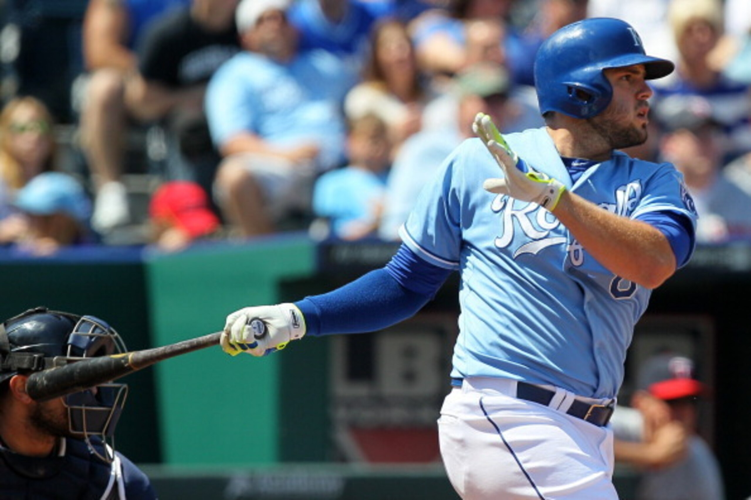 KANSAS CITY, MO - APRIL 19:  Mike Moustakas #8 of the Kansas City Royals hits a sacrifice fly in the fourth inning against the Minnesota Twins at Kauffman Stadium on April 19, 2014 in Kansas City, Missouri. (Photo by Ed Zurga/Getty Images)