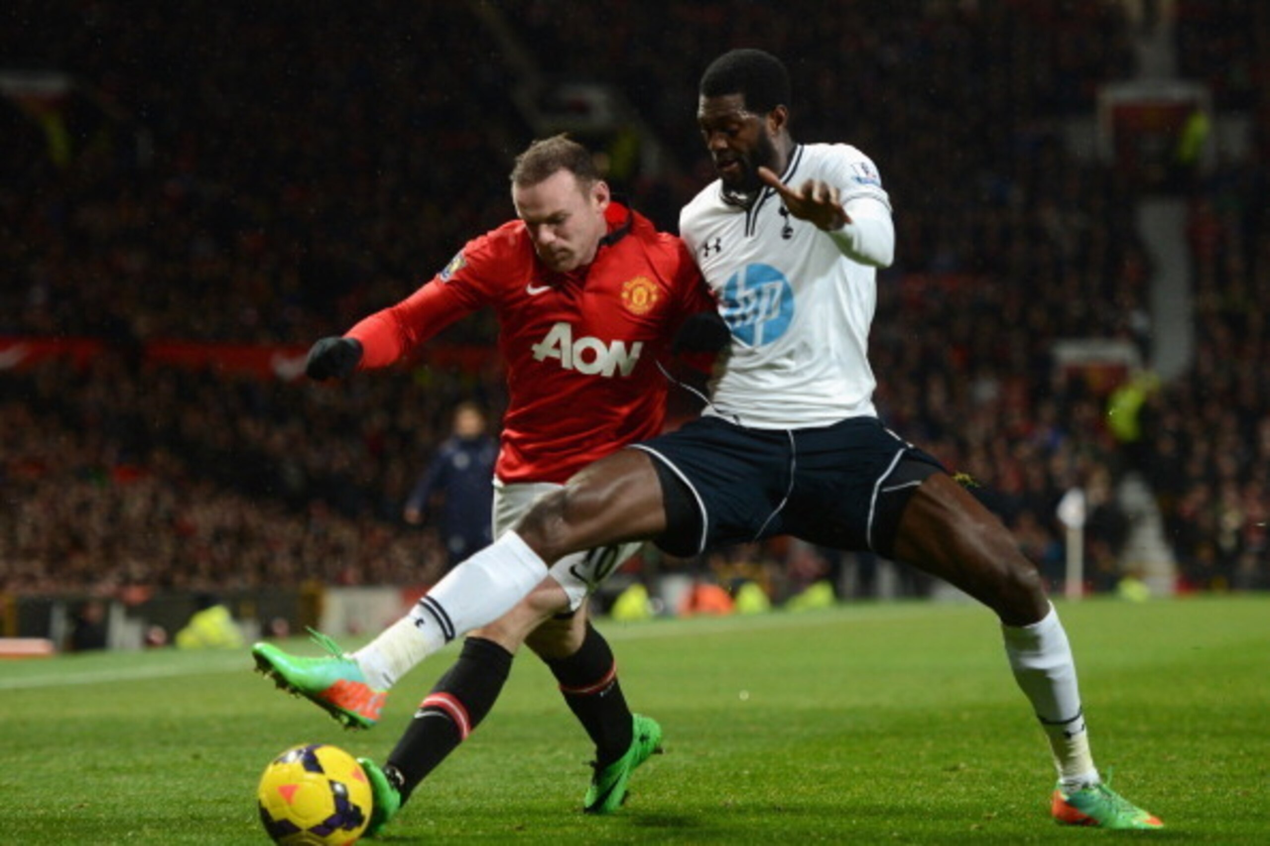 MANCHESTER, ENGLAND - JANUARY 01:  Emmanuel Adebayor of Tottenham Hotspur battles for the ball with Wayne Rooney of Manchester United during the Barclays Premier League match between Manchester United and Tottenham Hotspur at Old Trafford on January 1, 20